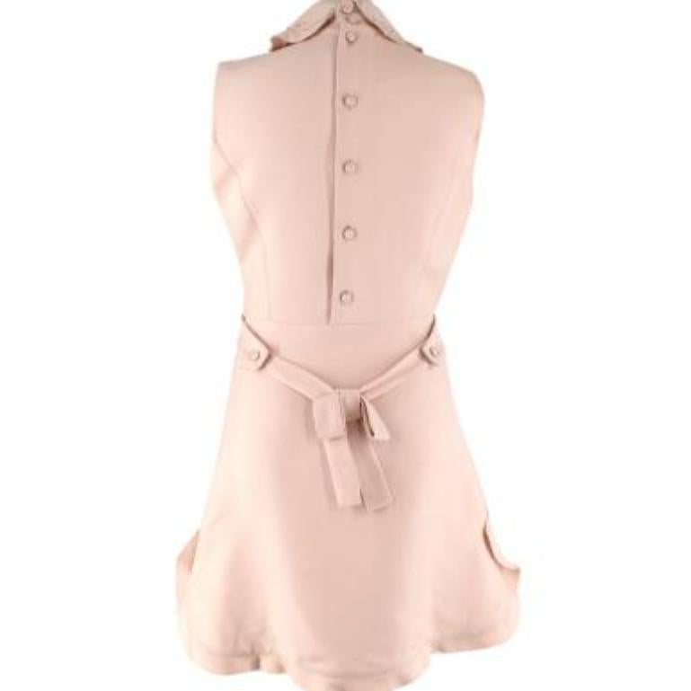 Miu Miu Nude Ruffle Mini Dress with Embellished Collar

- Pinafore style mini dress in nude pink crepe
with a crystal and faux pearl embellished collar
- Ruffled hems
- Bow at the waist
- Zip down the side and buttons down the back 
- Semi-lined