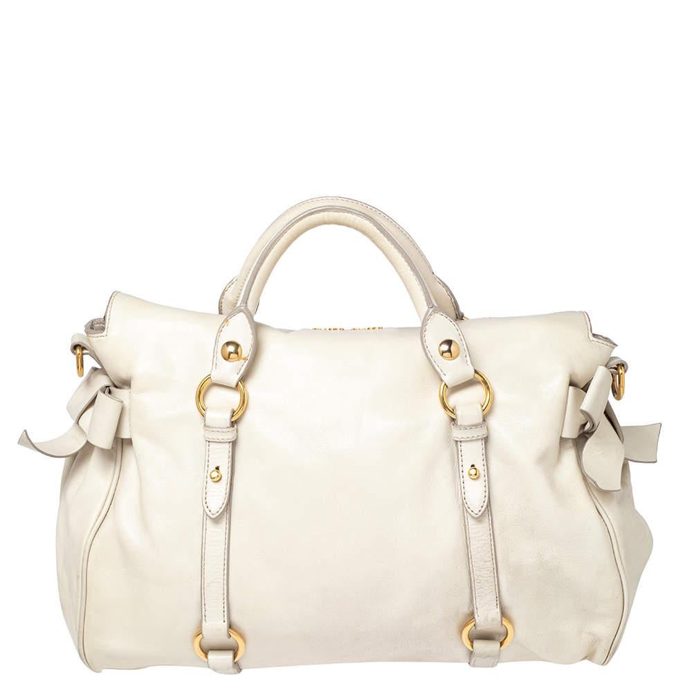 Masterfully crafted in leather, decorated with bows and lined with fabric, this satchel from the house of Miu Miu is both stylish and durable. In a lovely off-white shade, this is the perfect pick for your outfit goals!

Includes: Original Dustbag,