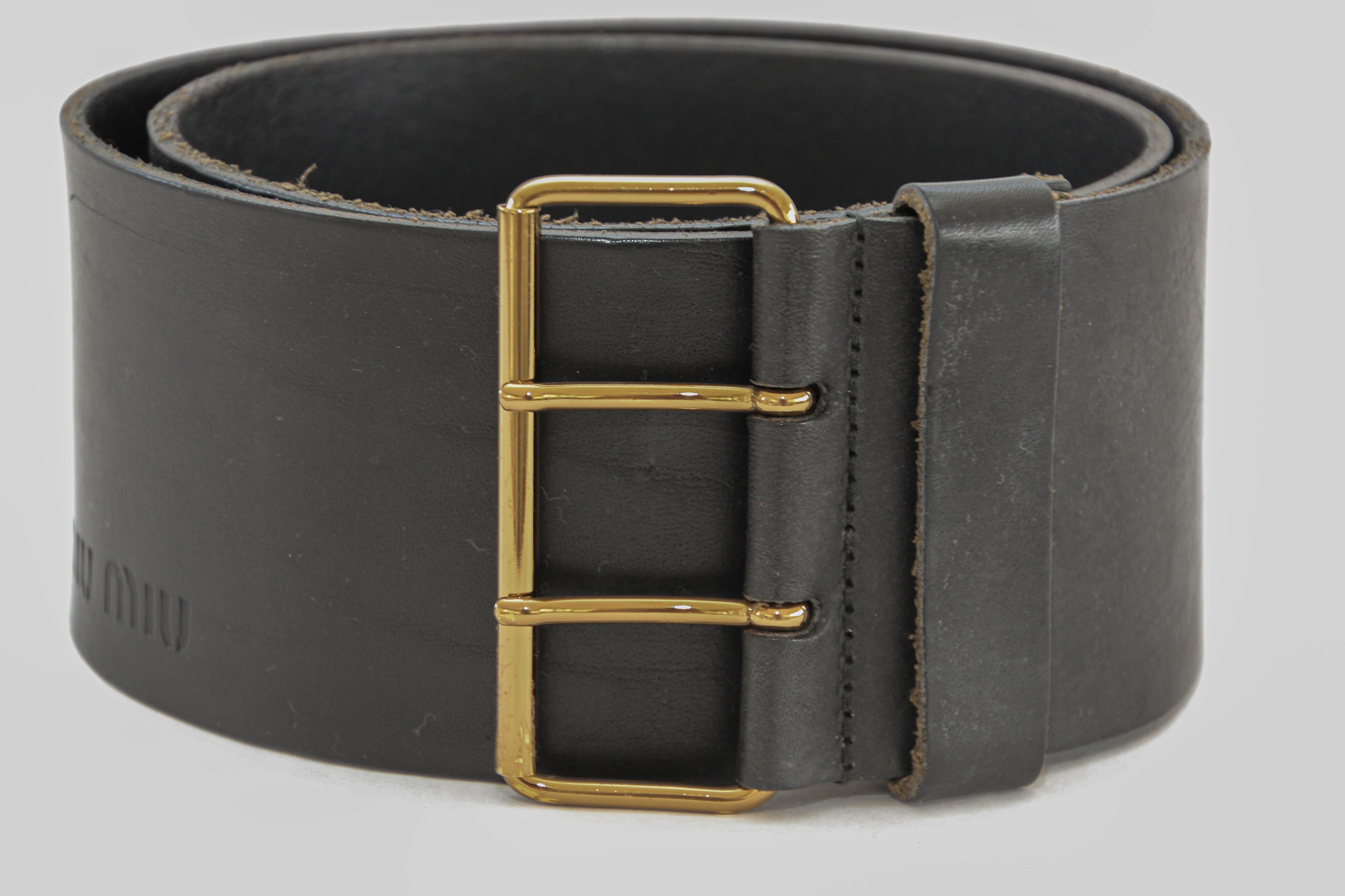 MIU MIU Oversized Black Leather Wide Waist Belt.
This Miu Miu belt is the perfect addition to your accessory collection. Crafted in black leather, this oversized waist belt will provide you with enough to glam up any basic outfit.
Luxury wide