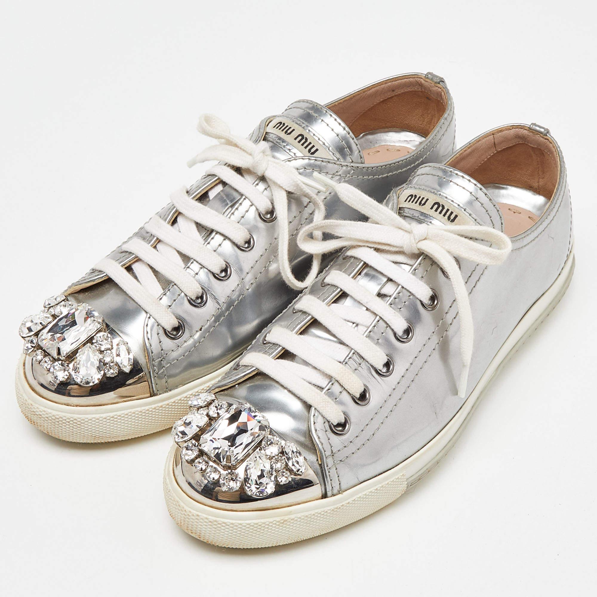 Who says sneakers cannot have a touch of sparkle? These Miu Miu sneakers are brilliantly crafted from patent leather and detailed with lace ups and crystals. They are set on comfortable rubber soles and make a great pair to dresses and skirts alike.