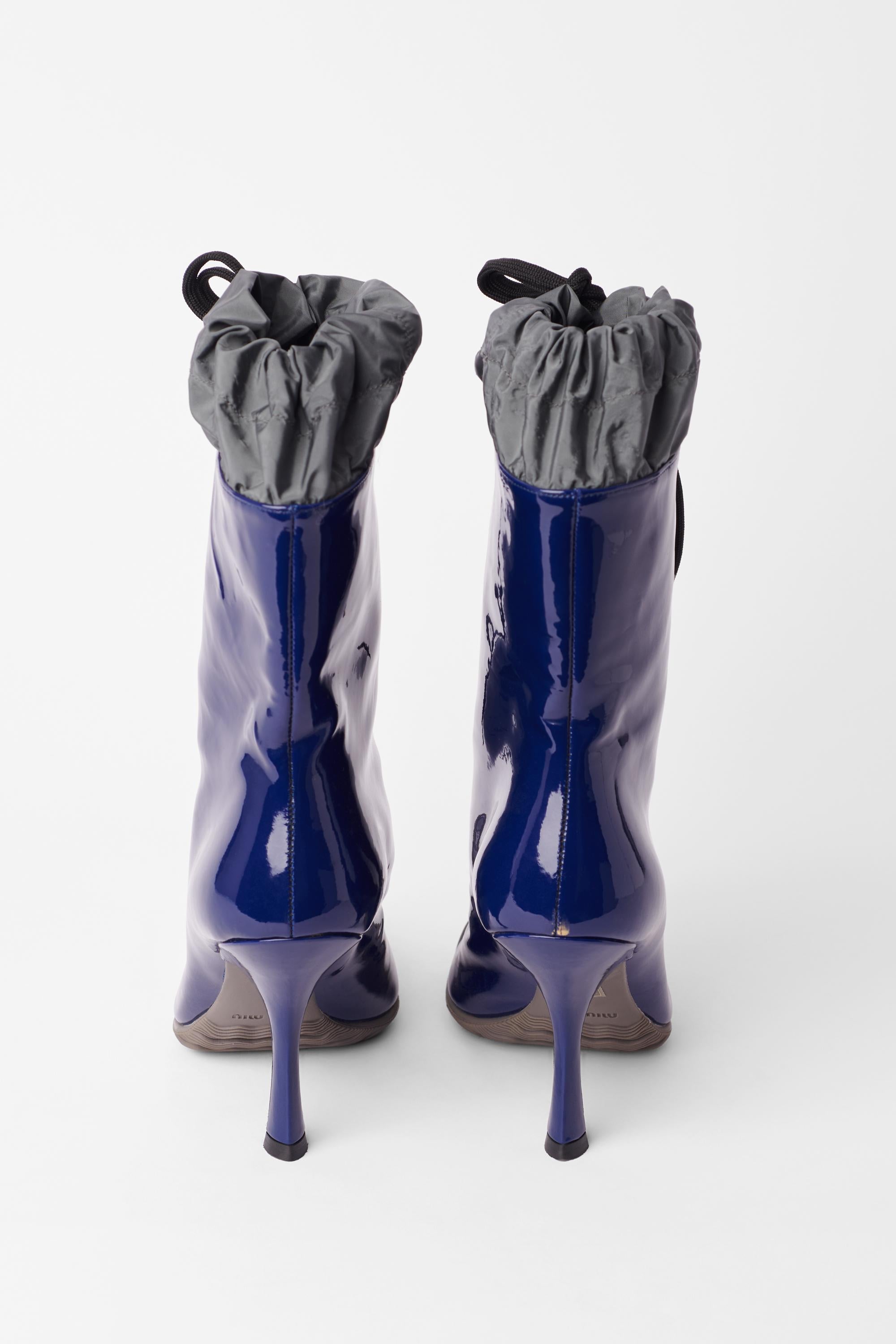 Miu Miu patent welly heel boots. Features rubber sole, patent leather main and drawstring upper. In excellent vintage condition, brand new. Authenticity Guaranteed.

Tag Size: EU 36
Modern Size: UK: 3.5, US: 5.5, EU: 36
Fabric: Rubber, Patent
