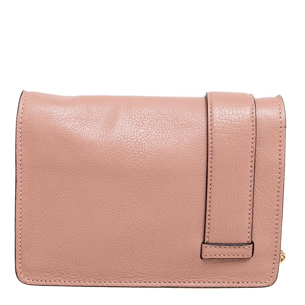 A pretty flap bag in pink leather highlighted by a crystal-embellished buckle on the front. It is held by a shoulder chain and lined with satin. The bag is a fine mix of quality and appeal. Add a touch of Miu Miu's youthful charm to your look with