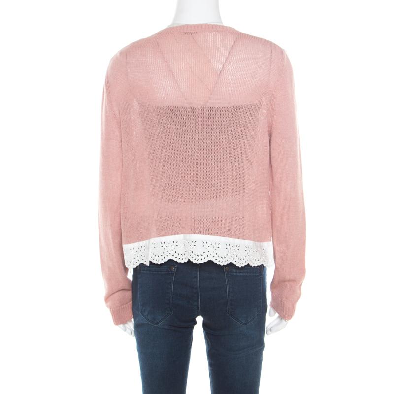Comfortable and stylish, this sweater from Miu Miu definitely needs to be on your wishlist! The pink creation is made of 100% cotton and features a contrasting lace trim detailing at the bottom and ties on the sides. It flaunts a round neckline and