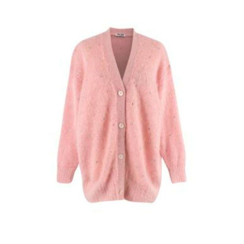Miu Miu Pink Crystal Embellished Mohair Blend Cardigan

-Button fastening 
-Crystal embellishment body 
-V neck 
-Ribbed cuffs & hem 

Material: 

67% mohair 
28% polyamide 
5% wool 

Made in italy 

PLEASE NOTE, THESE ITEMS ARE PRE-OWNED AND MAY