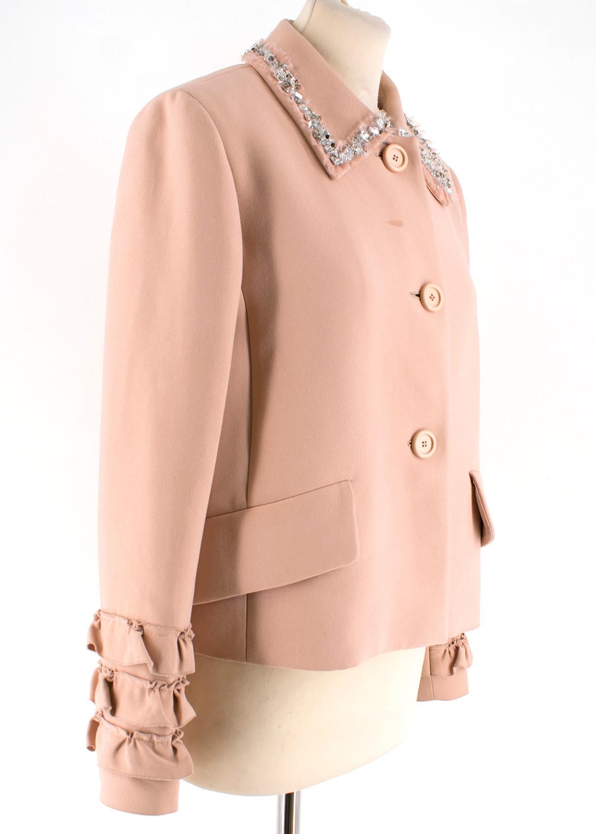 Miu Miu blush pink blazer. Featuring ruffle detailing on the cuffs and silver coloured embroidery around the collar. Front button closure with three blush pink buttons. Pockets still sewn shut. Dry clean only. Made is Italy. 

Please note, these