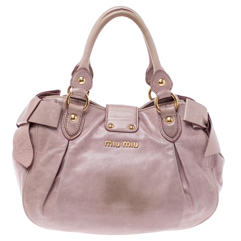 Flaunt classic fashion wherever you go with this Miu Miu bag. It is crafted from distressed leather and the lock on the flap leads to a spacious satin interior for your essentials. Held by top handles and a shoulder strap, this pink accessory is