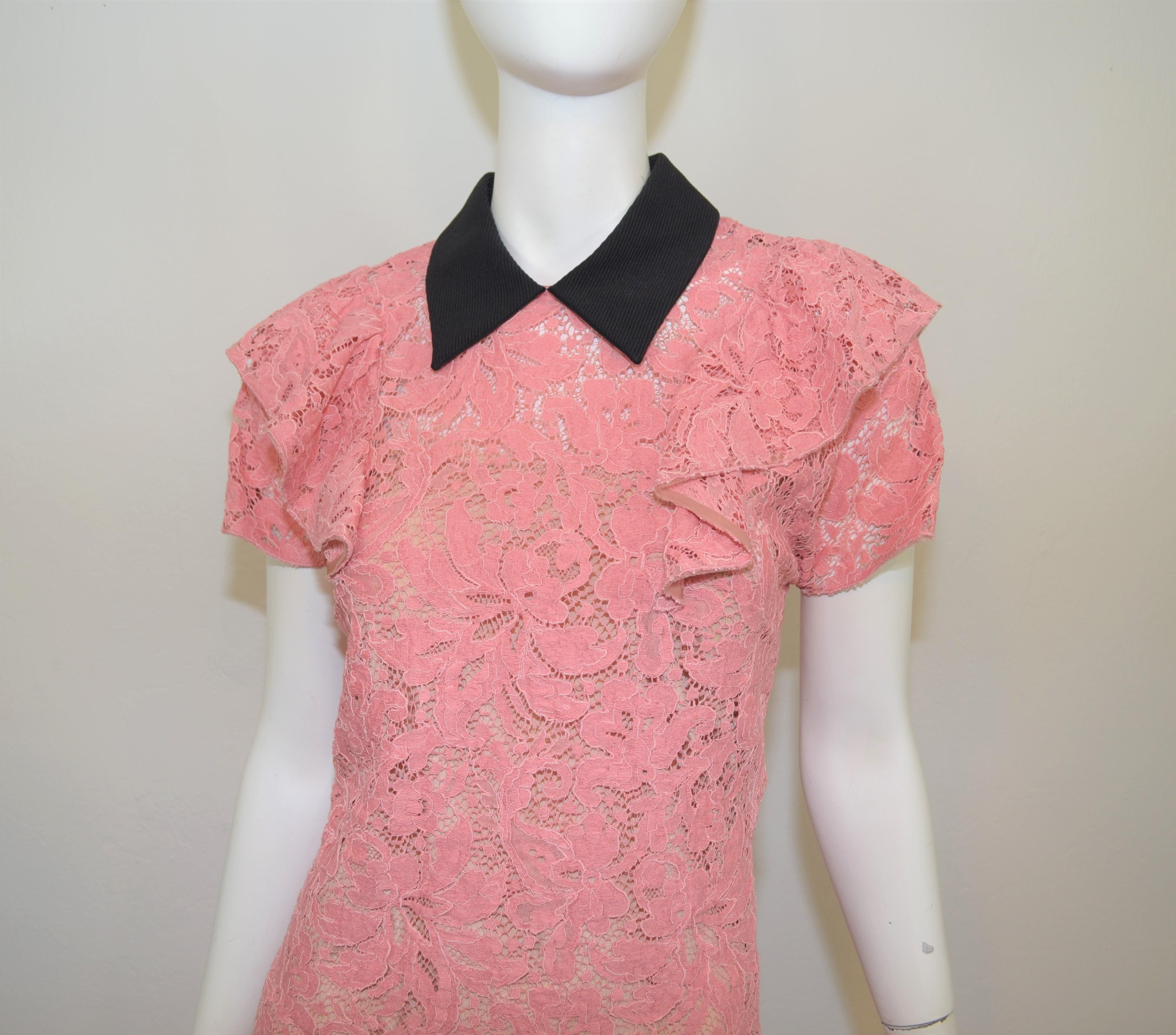 Miu Miu lace dress is featured in pink with a black collar. Dress has an under slip and a back zipper and hook-and-eye closure. Dress is a size 42, made in Italy.

Measurements:
Bust – 38”
Waist – 34”
Hips – 36”
Length – 34.5”