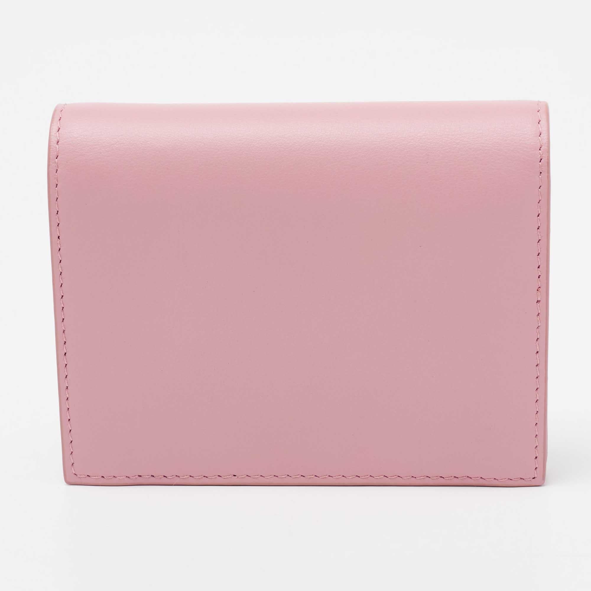The cute bow detailing and the brand signature decorate the pink exterior of this Miu Miu wallet. Crafted from leather, its compartmentalized interior will keep your monetary essentials organized.

Includes: Original Box, Authenticity Card, Info Card