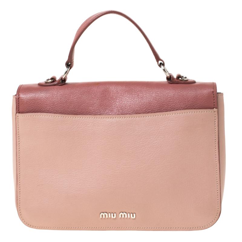 Stunning to look at and durable enough to accompany you wherever you go, this Miu Miu crossbody bag is a joy to own! This Madras bag is crafted from leather and held by a top handle and a shoulder strap. The insides are satin-lined and perfectly