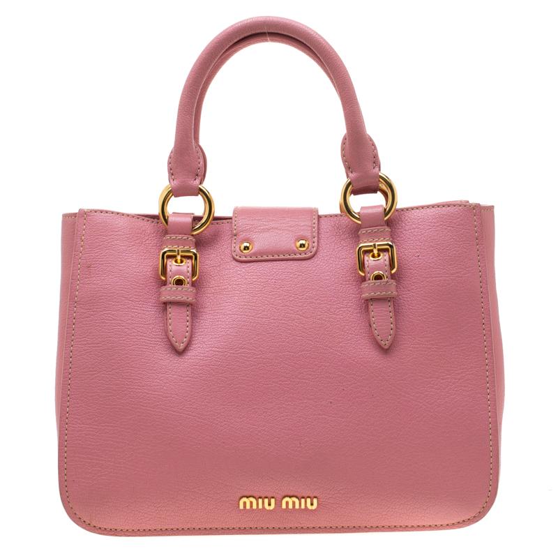 This elegant Madras tote from Prada will make a valuable addition to your collection. The tote is crafted from pink leather and features a chic silhouette. It has dual handles, a shoulder strap and a suede lined interior that is spacious enough to