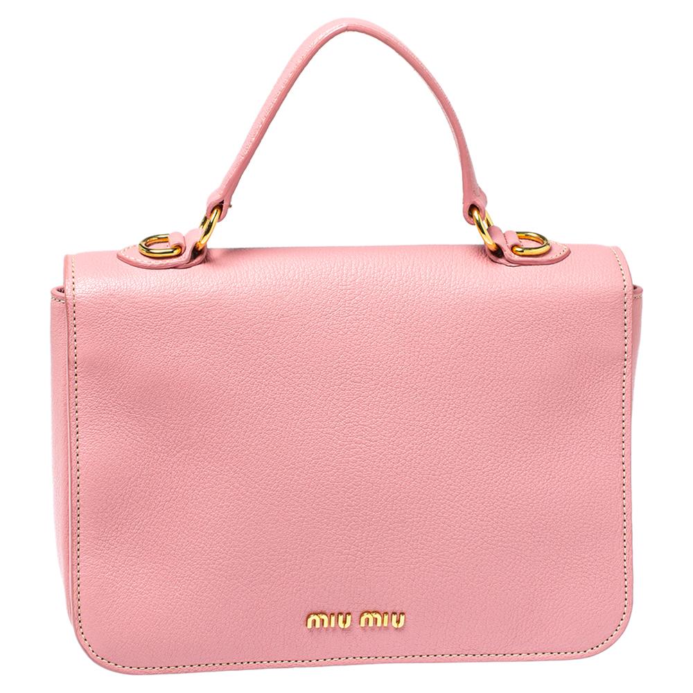 A chic bag for you to step out in style and win compliments! This pink bag from Miu Miu comes crafted from Madras leather and features a front gold-tone lock detailed flap. It has a top handle and a detachable shoulder strap and opens to a spacious