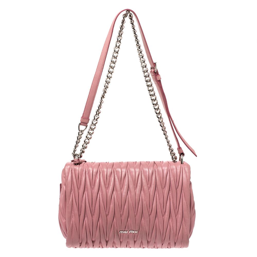 Now here's a bag that is both stylish and functional! Miu Miu brings us this gorgeous crossbody bag that has been crafted from pink leather and designed using the Matelasse technique. It has a silver-tone top closure on the front flap that opens up