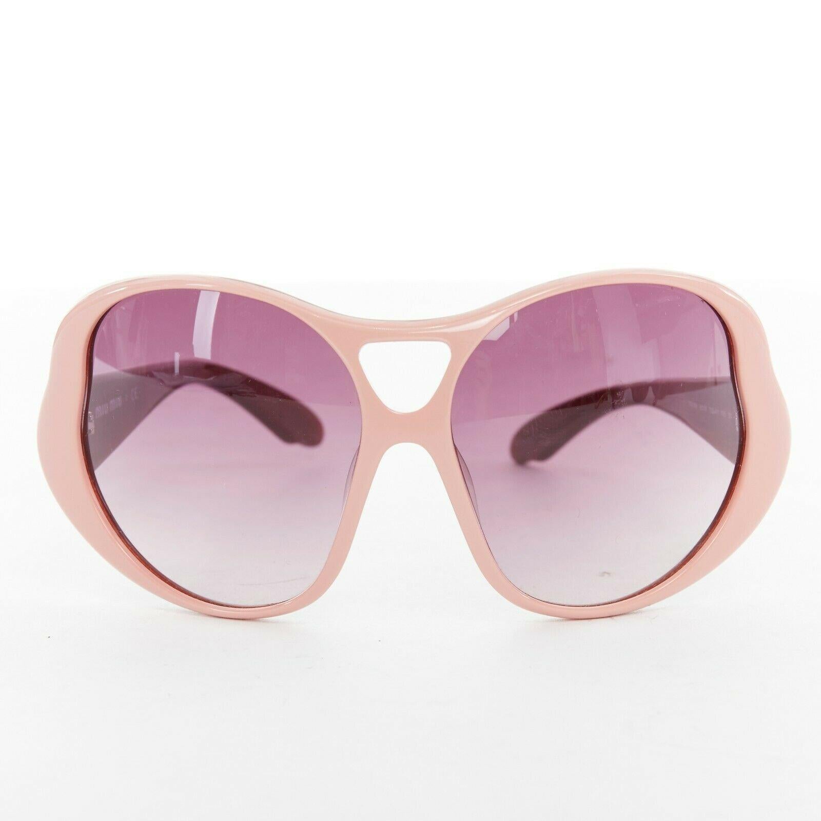 MIU MIU pink plastic oversized butterfly frame purple gradient lens sunglasses Reference: CAWG/A00161 
Brand: Miu Miu 
Designer: Miuccia Prada 
Material: Frame Plastic 
Color: Pink 
Extra Detail: Pink plastic frame. Purple gradient lens. Oversized