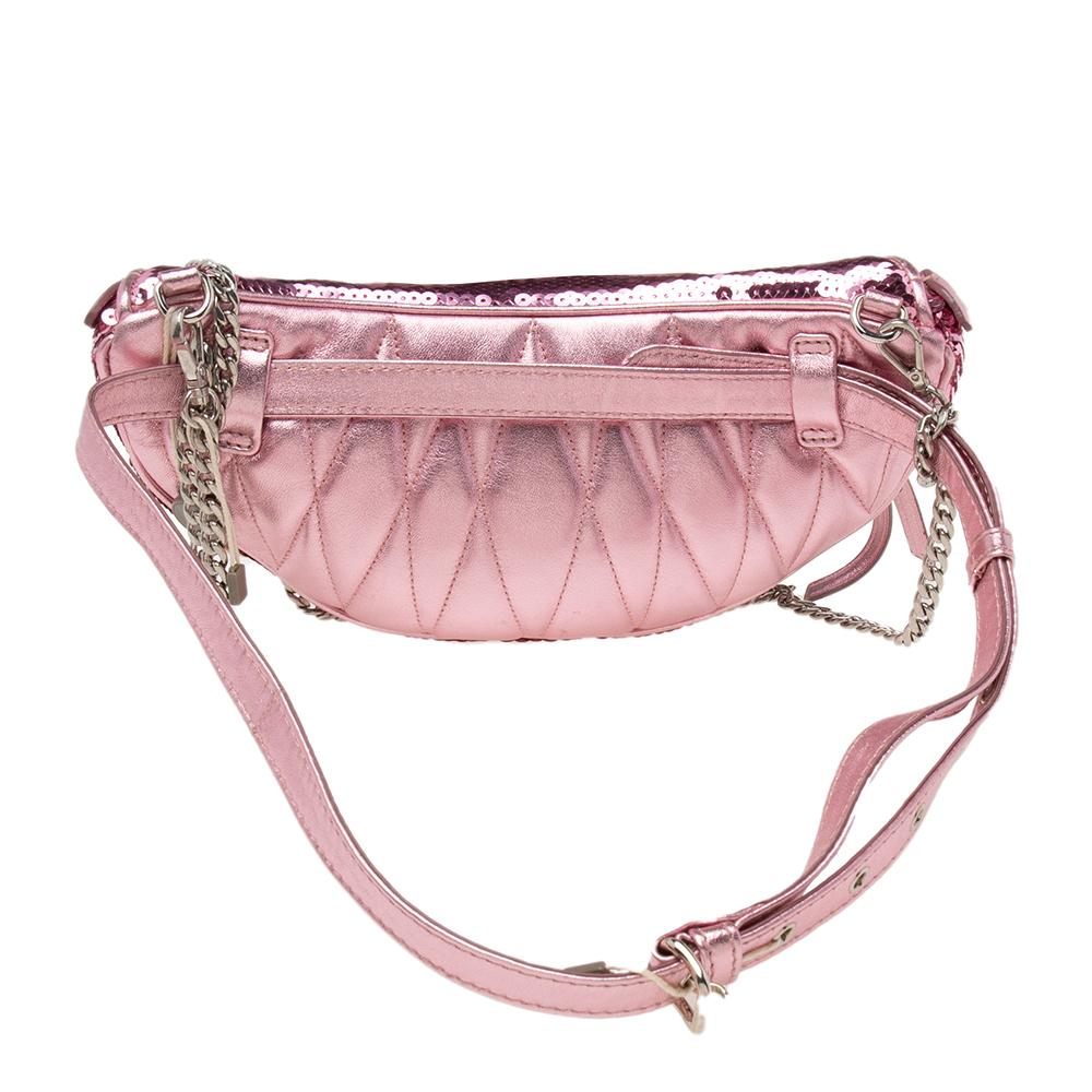 Belt bags are back in style and we are not disappointed! This pink one from Miu Miu is crafted with leather and sparkling sequins and is detailed with the brand logo on the front. It comes with a chain strap and is equipped with a smooth satin