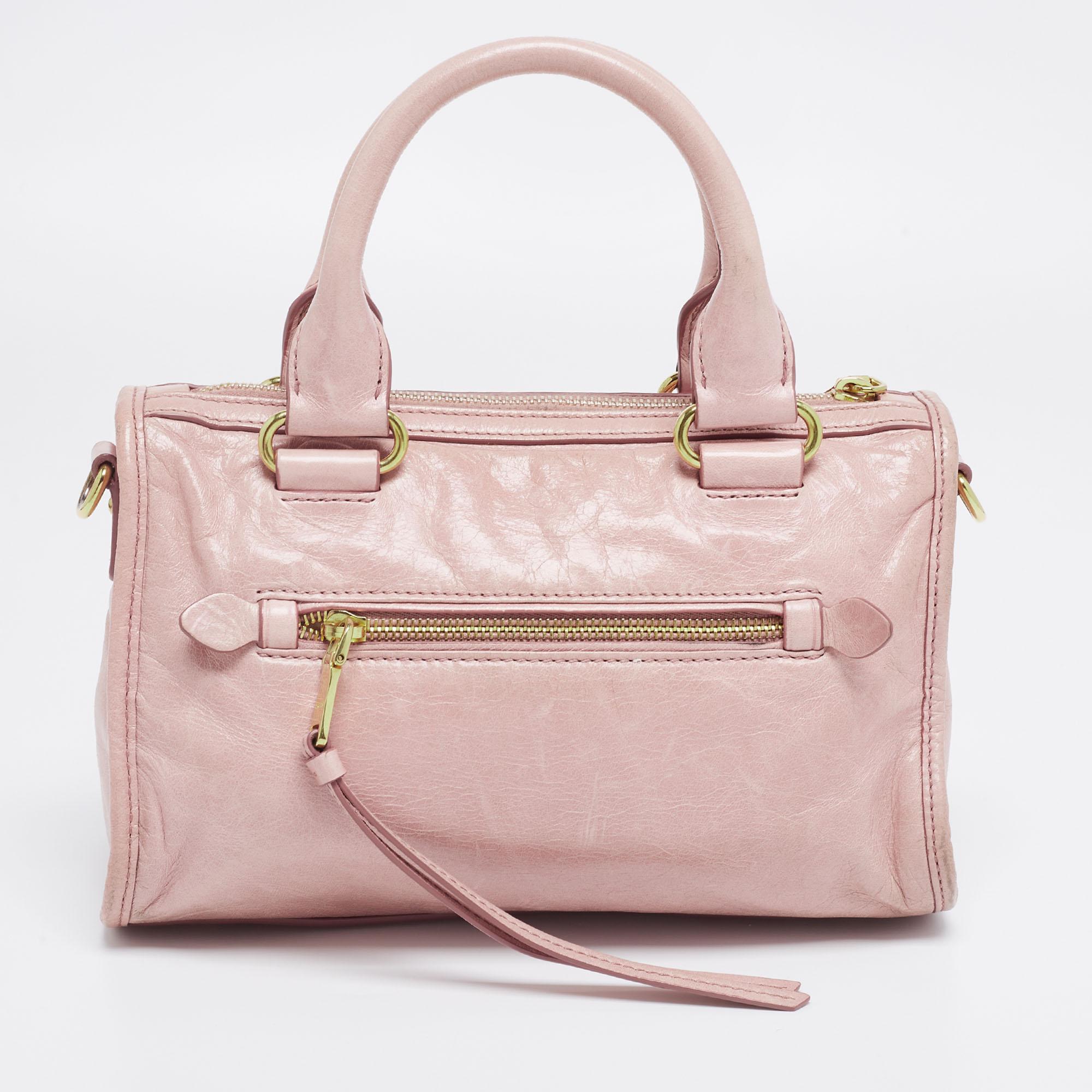 This satchel by Miu Miu is adorned in beautiful color that adds to its versatility. Accented with pretty details and polished hardware, this bag will effortlessly adapt to a myriad of ensembles.

Includes: Detachable Strap