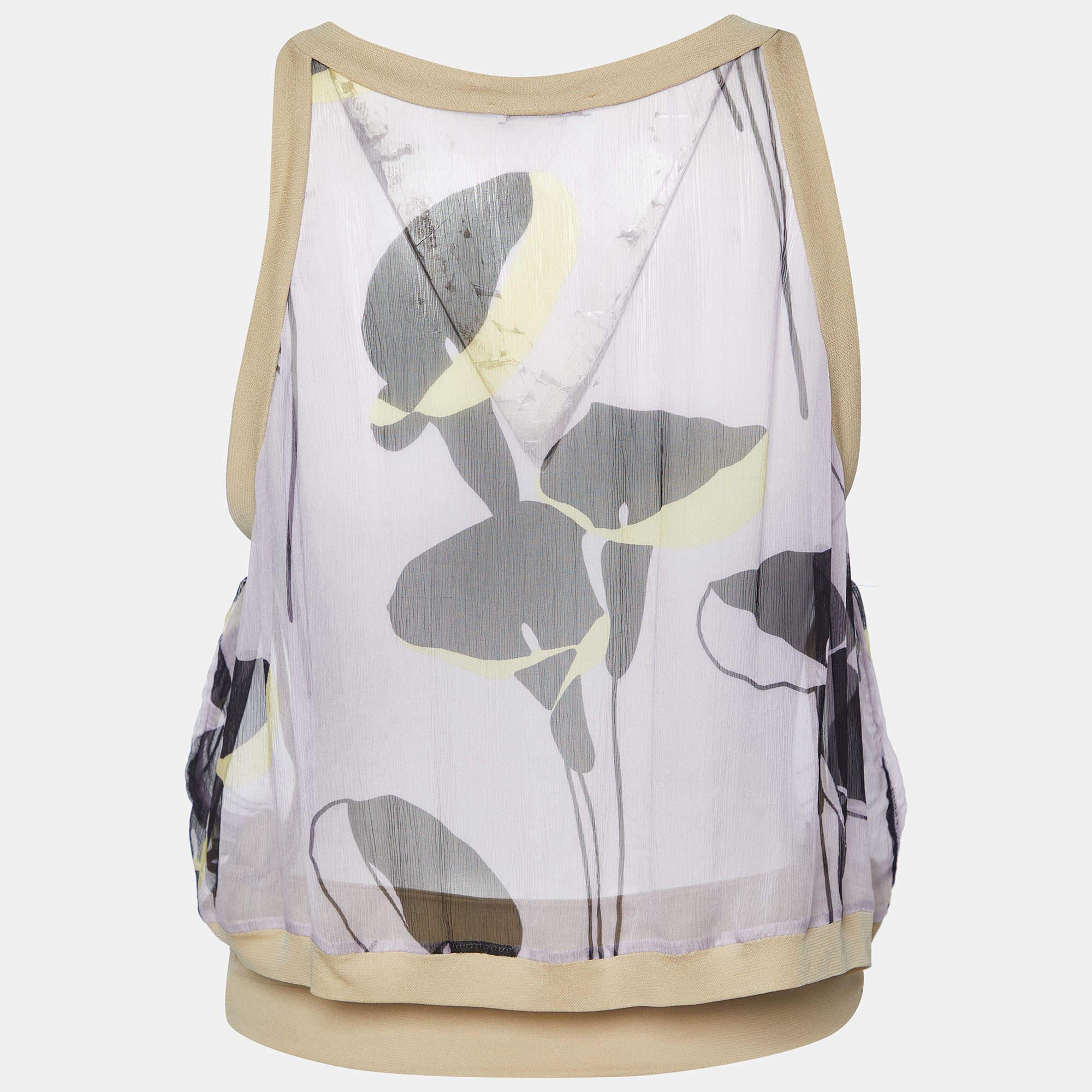 Dieses Designertop bietet Stil und Komfort. Die Kreation wurde aus den besten Stoffen geschneidert und mit vielen Details versehen. Kombinieren Sie es mit einem Rock und Absätzen.