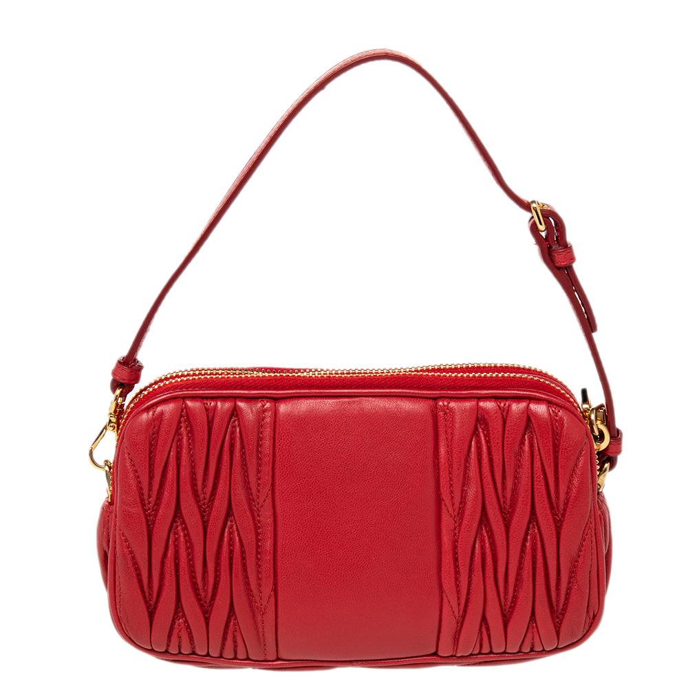 Here's a clutch from Miu Miu that is both stylish and functional! Crafted from red leather with the brand's signature matelassé technique, the clutch is divided into two sizeable compartments that make it easy to organize your daily essentials. It