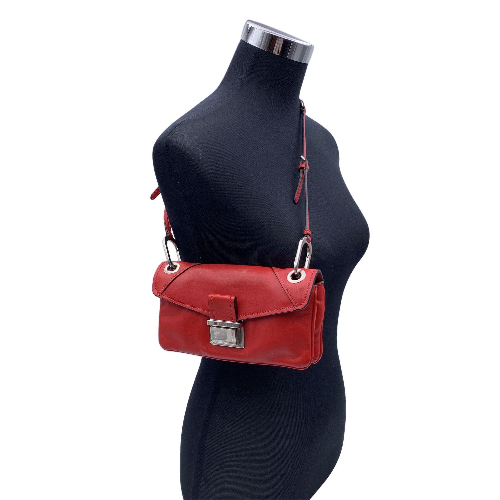 Miu Miu small mini shoulder bag , mod. RR1926, crafted in red leather. It features a flap closure , silver metal hardware, black leather lining and 1 side zip pocket and 1 middle zip pocket inside. . MIU MIU lettering on the back. Adjustable and