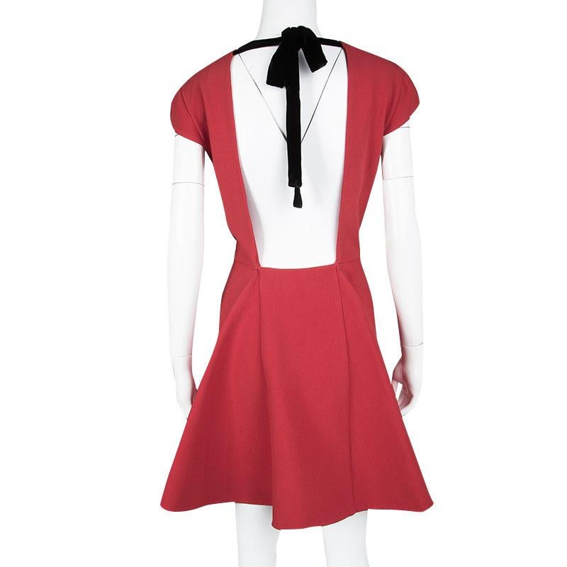 Wear it through the day or dress it up for the nights, this Miu Miu Cady dress is effortlessly stylish and chic. Designed in a red silk blend fabric, this dress features a round neckline with cap sleeves, fitted bodice and a flowy A line skirt. With