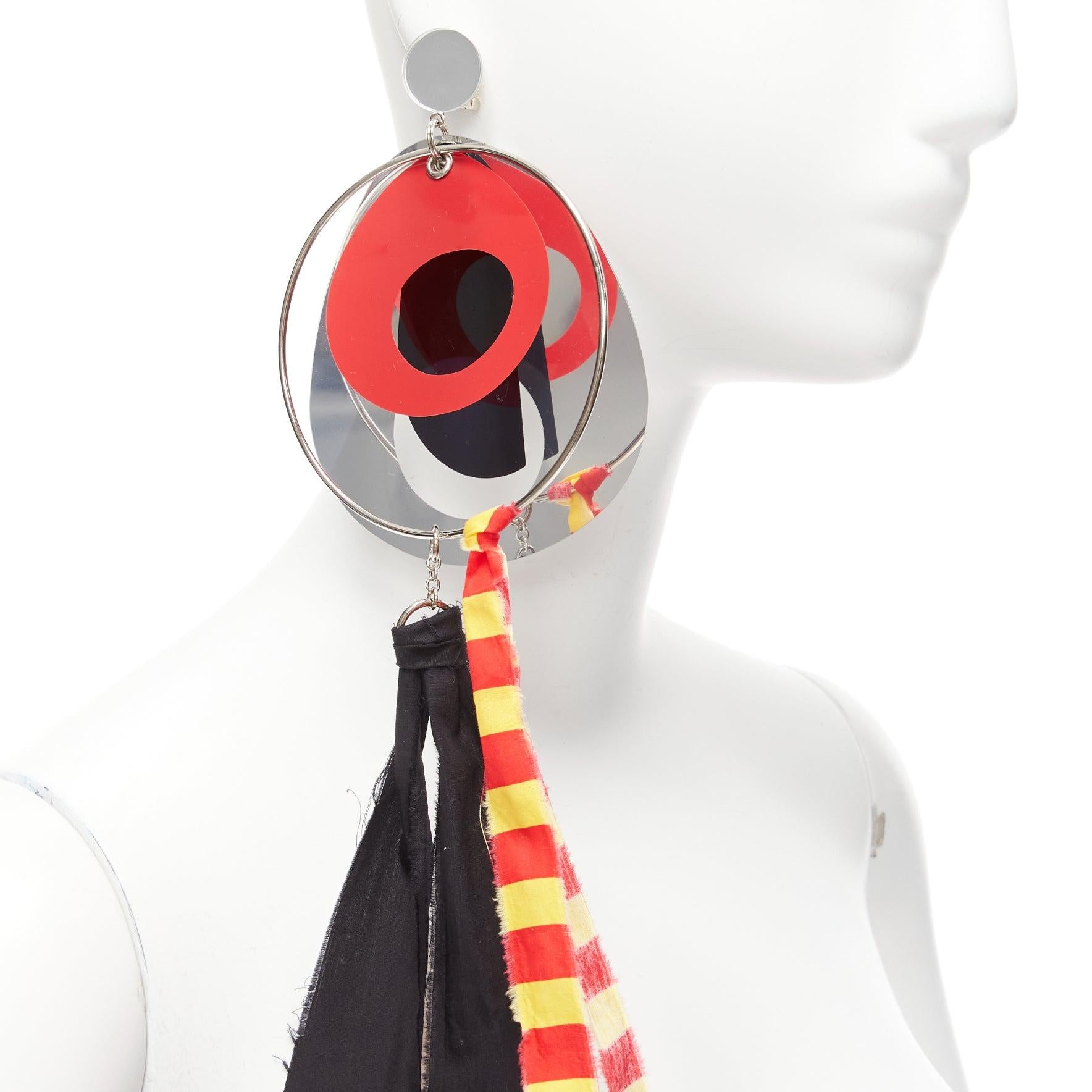 MIU MIU red silver plastic film hoop ribbon clip on statement earring Single
Reference: NKLL/A00092
Brand: Miu Miu
Designer: Miuccia Prada
Material: Plastic, Cotton
Color: Multicolour
Pattern: Solid
Closure: Clip On
Extra Details: Cliip on earring.