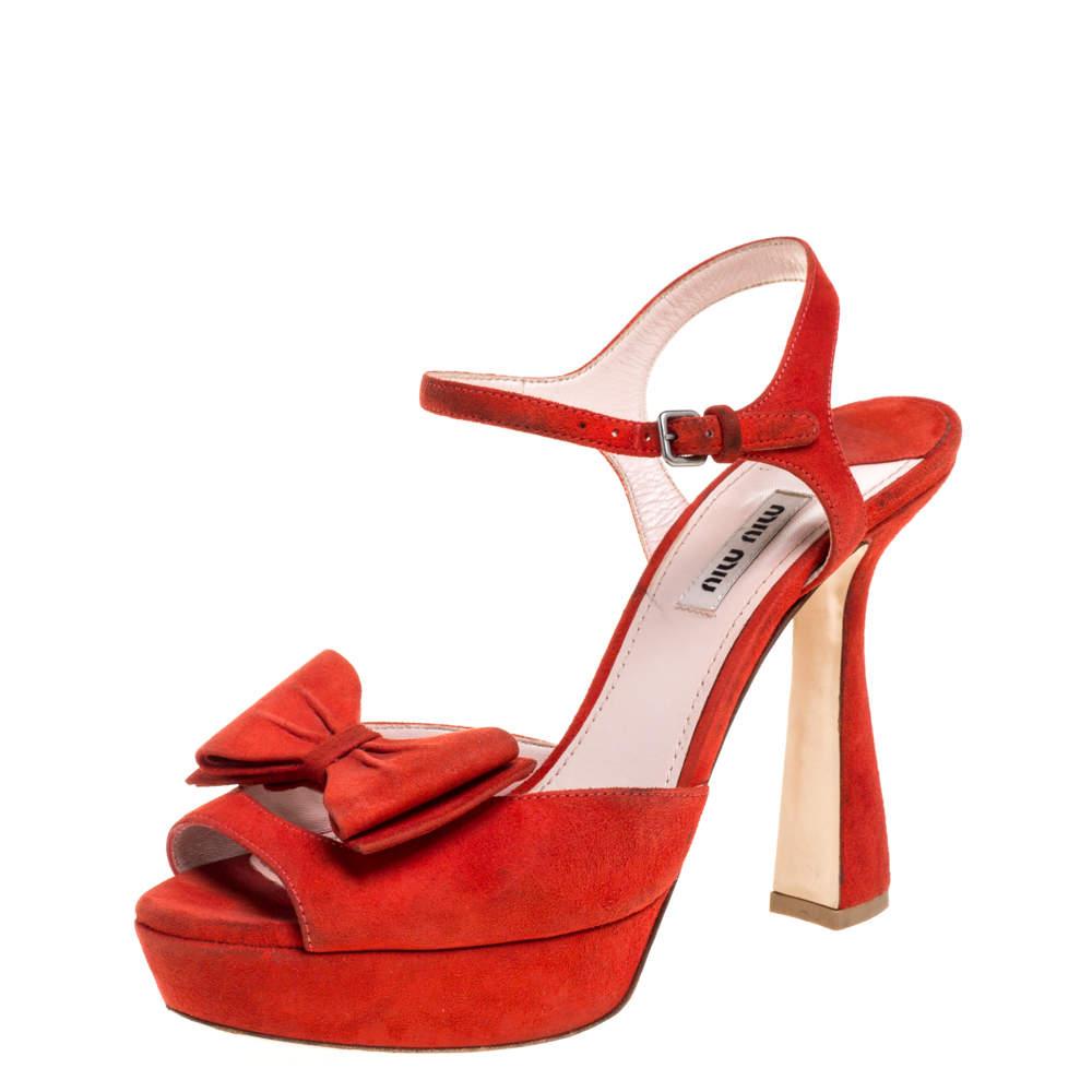 Miu Miu opts for elegance glamour with these stunning red sandals. They're made from soft suede in a red hue with smooth leather soles and lining set on statement platforms and block heels with ankle straps. These sandals are adorned with dainty