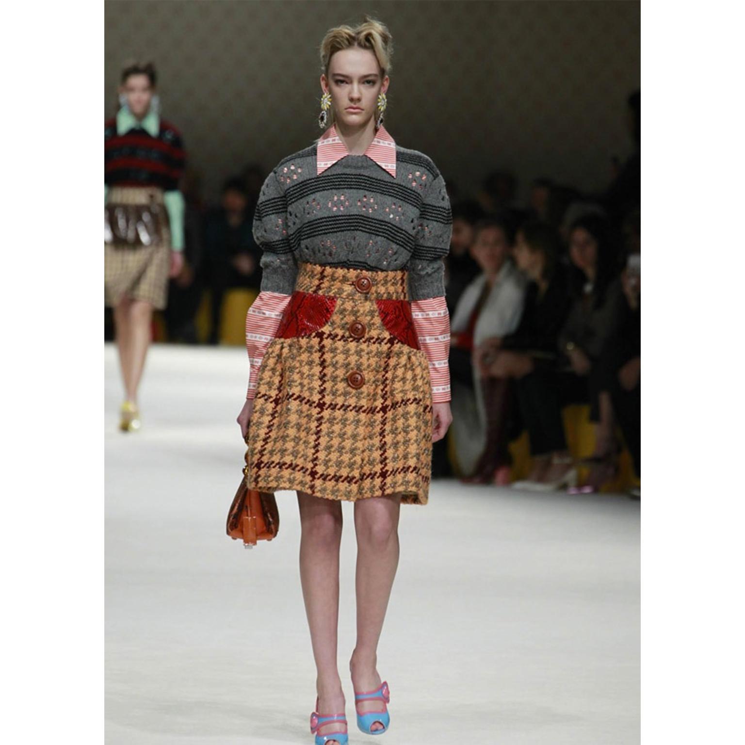 This fun Miu Miu red and white print was featured in various styles on the Fall / Winter 2015 runway. The pattern is red and white stripes with southwestern patterns. The top has
hidden snap closures down the center front with one pearlescent white