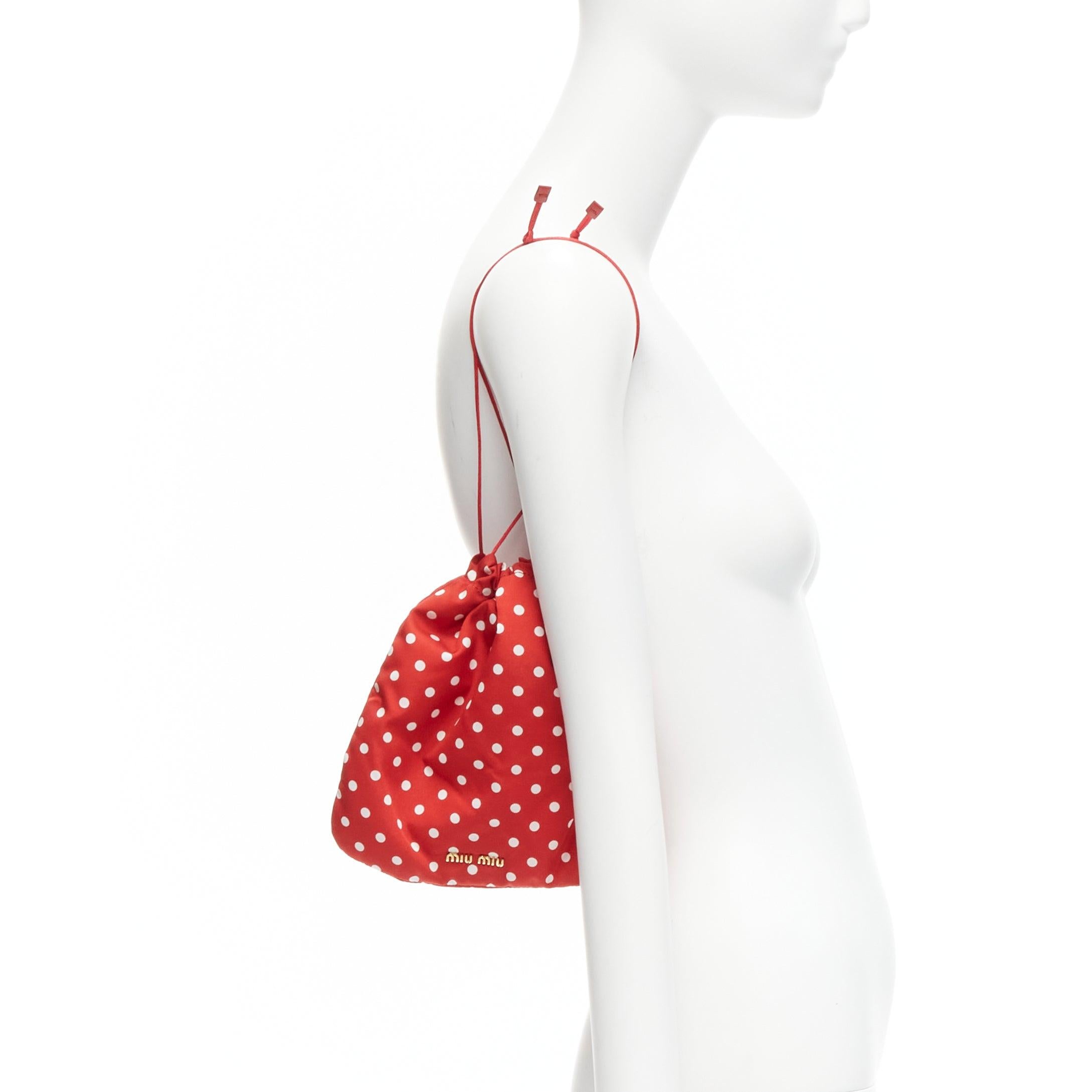 MIU MIU red white polka dot fully lined fabric drawstring pouch bag
Reference: BSHW/A00075
Brand: Miu Miu
Designer: Miuccia Prada
Material: Feels like nylon
Color: Red, White
Pattern: Polka Dot
Closure: Drawstring
Lining: Red Fabric
Extra Details: