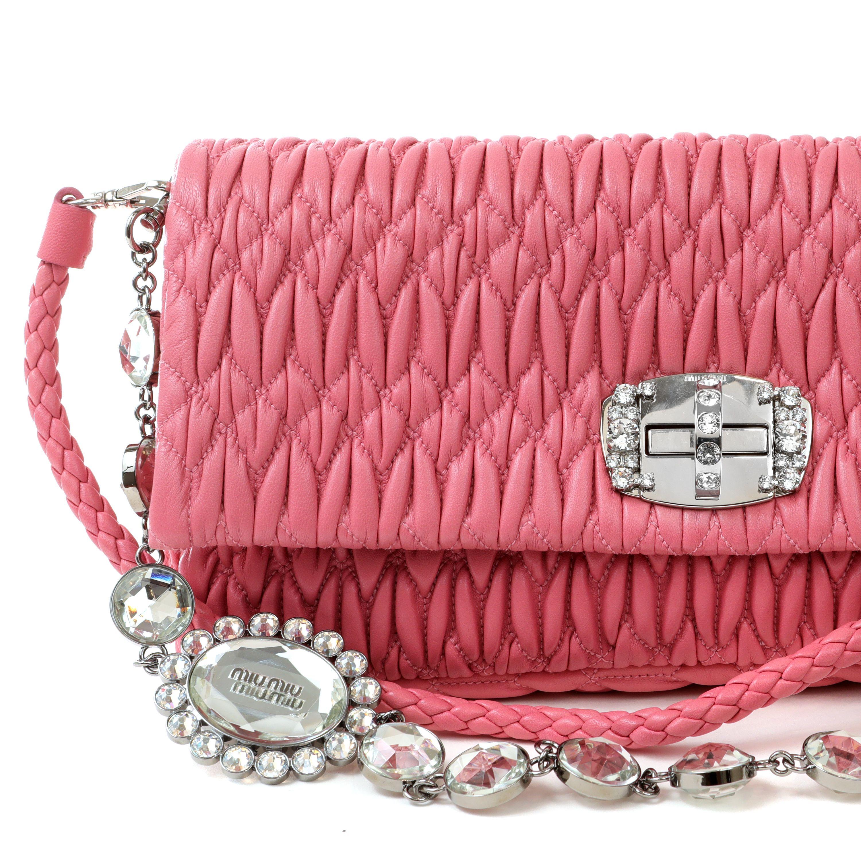 This authentic Miu Miu Rose Pink Crystal Cloquè Small Bag is in pristine condition.  The iconic design features deep pink quilted Nappa leather and a crystal turn lock closure.  May be carried by the detachable leather strap or the decorative