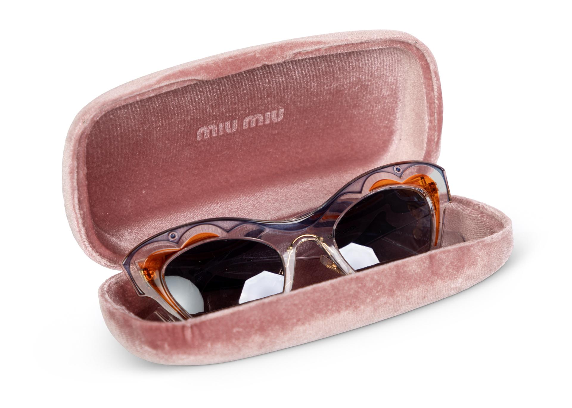 From the Spring 2014 , featured on the runway and that season's eyewear campaign modeled by Elle Fanning.
Transparent plastic sunglasses with blue and orange design. Gold tone logo at the temple and gradient lenses. Comes with case and dust cloth.