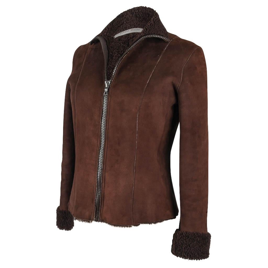 Mightychic offers a Miu Miu vintage fabulous fitted chocolate brown shearling jacket with a timeless cut and design.   
Bold front zipper with a high neck can be folded over.  
Sleeve can cuffed up.  
Stitch detail.  
Classic wearable jacket.
Light