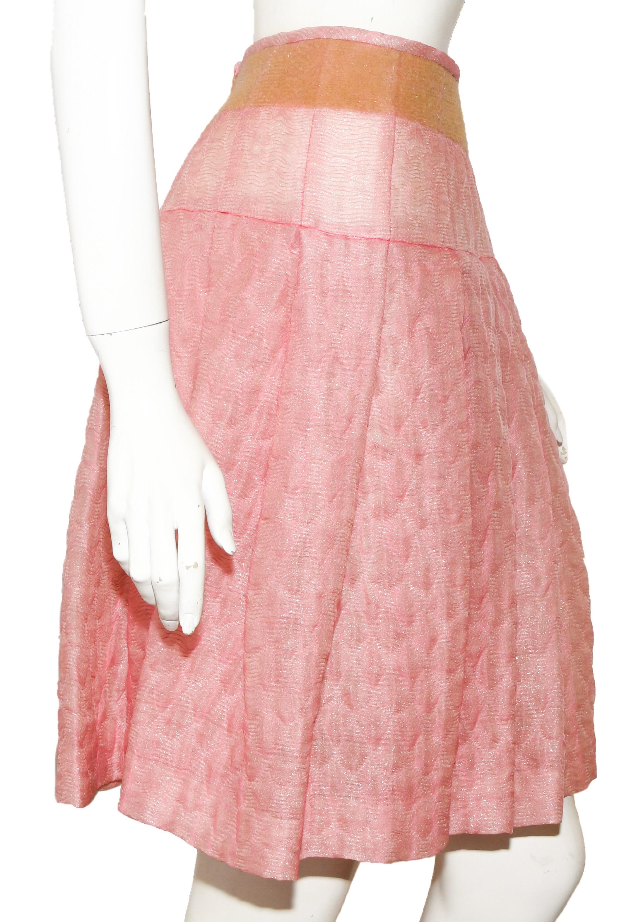 Miu Miu silk blend pink quilted skirt features wide pleats all around created by layered fabrics and quilted together to create a newly designed skirt.  This skirt has two bands-- one at the waist in beige then another band at the hips continued by