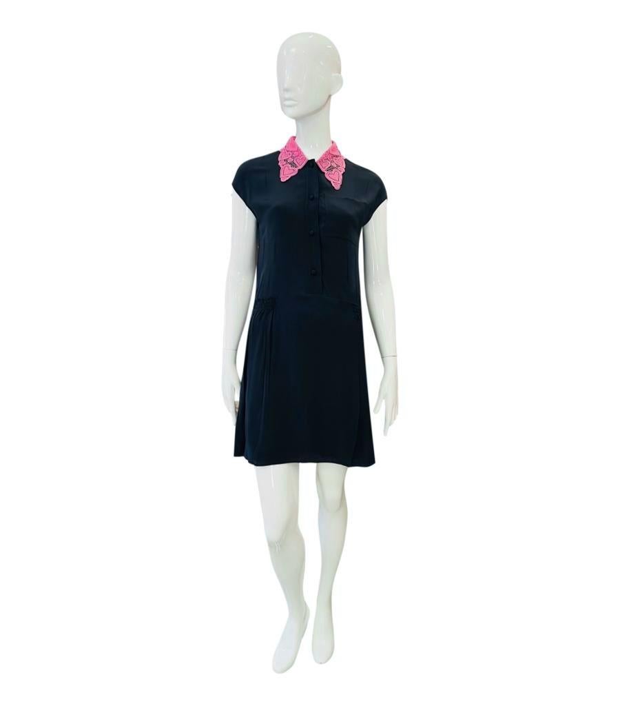 Miu Miu Silk Dress With Heart Lace Collar

Navy mini dress designed with heart lace collar and chest pocket.

Featuring cap sleeves, button closure to the top and flared skirt with elasticated plisse inserts around the back.

Size – 36IT

Condition