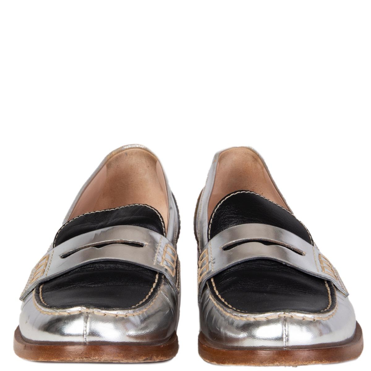 100% authentic Miu Miu penny loafers in black and metallic silver calfskin. Have been worn and are in excellent condition.

Measurements
Imprinted Size	37.5
Shoe Size	37.5
Inside Sole	24cm (9.4in)
Width	7.5cm (2.9in)
Heel	2cm (0.8in)

All our