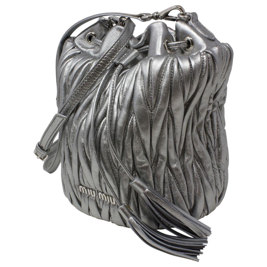 This bag is crafted from high-quality silver calfskin leather, featuring matching silver hardware and a secure drawstring closure. Inside, a slip pocket provides additional storage, making it as functional as it is fashionable.

SPECIFICS
• Length: