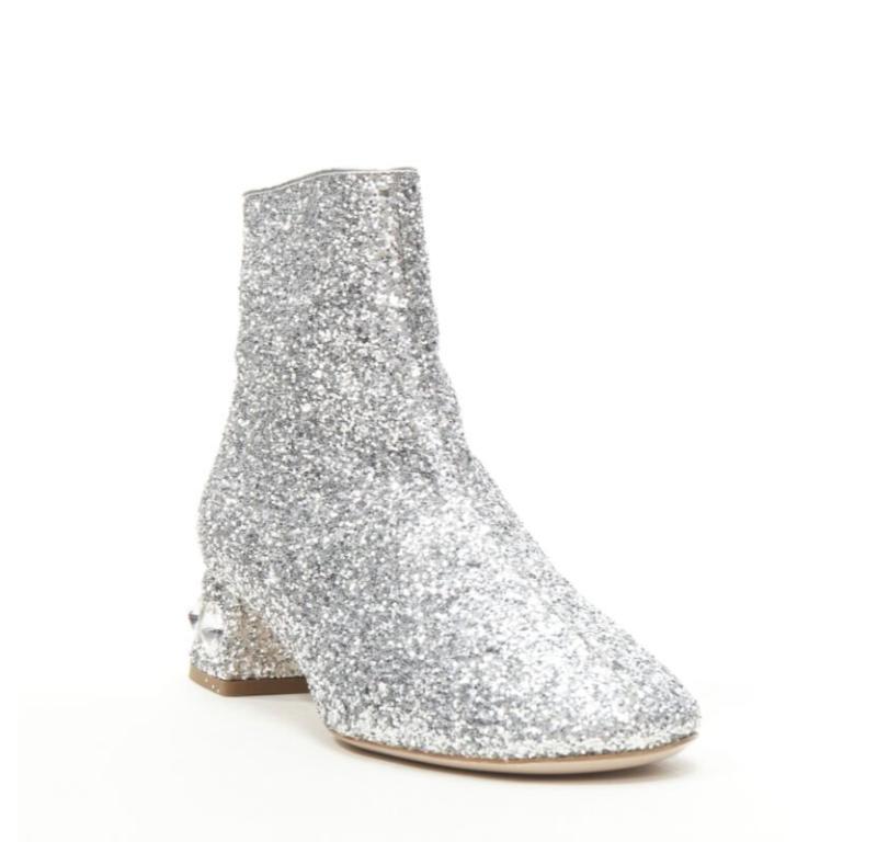 MIU MIU silver glitter large rhinestone crystal heel ankle boots EU37.5
Reference: TGAS/C01346
Brand: Miu Miu
Designer: Miuccia Prada
Model: 5T652C
Material: Leather
Color: Silver
Pattern: Solid
Closure: Zip
Lining:  Leather
Extra Details: Round toe