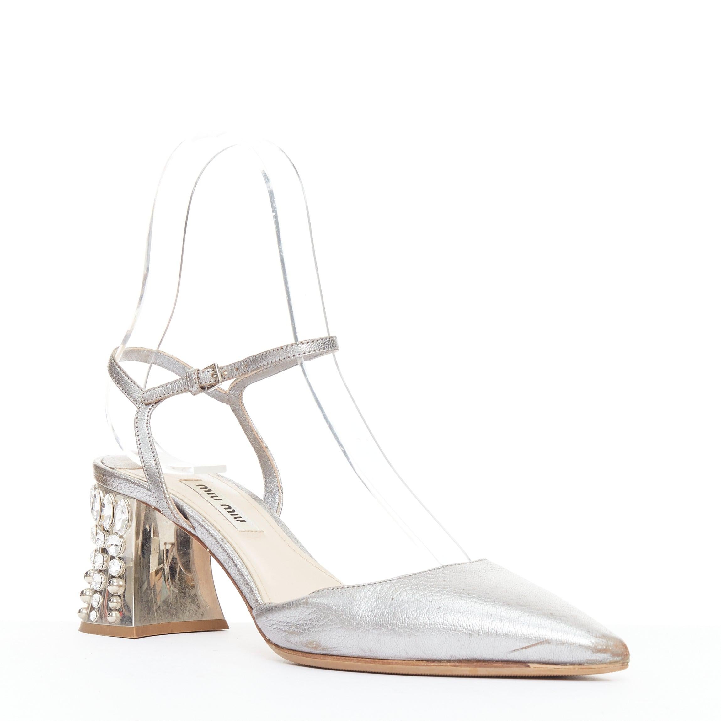 MIU MIU silver leather jewel embellished block heel pump EU35.5
Reference: GEGG/A00218
Brand: Miu Miu
Designer: Miuccia Prada
Material: Leather, Metal
Color: Silver, Clear
Pattern: Solid
Closure: Ankle Strap
Lining: Nude Leather
Extra Details: