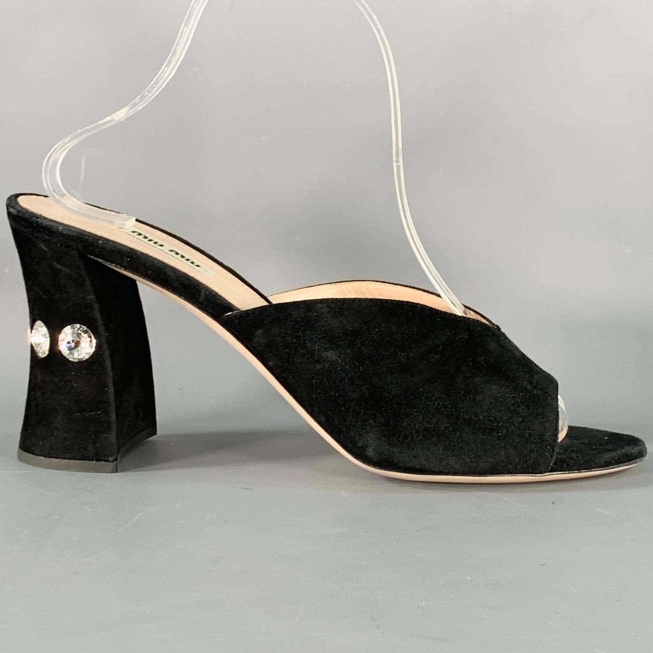 MIU MIU sandals
in a black suede featuring a peep toe, chunky heel with rhinestone studded design, and slip on closure. Made in Italy.New without Box. 

Marked:   IT 41 

Measurements: 
  Heel: 3.75 inches 
  
  
 
Sui Generis Reference: