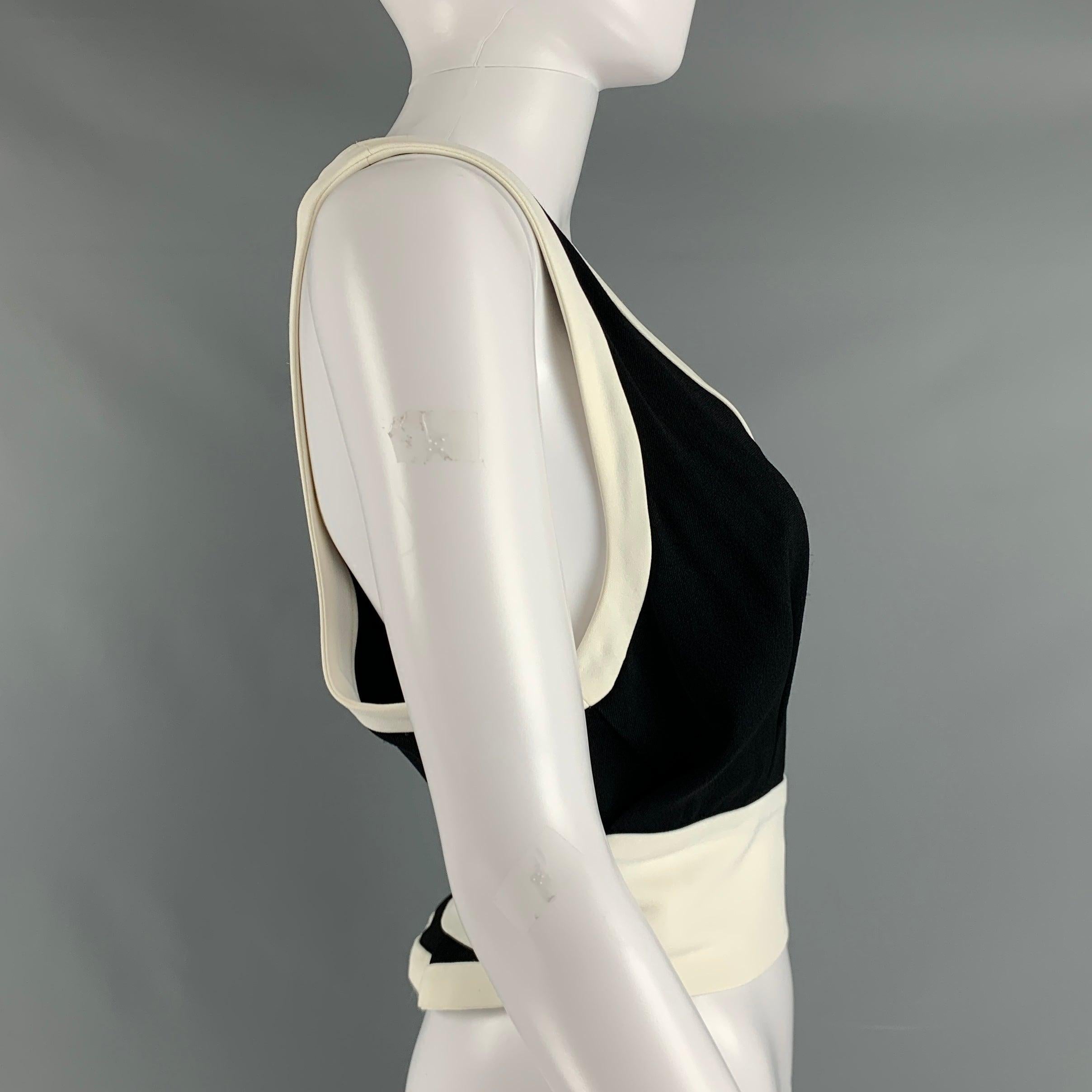 MIU MIU casual top comes in a black and cream viscose knit featuring a contrasting trim, wrap sash, and a v-neck. Made in Italy.Very Good Pre-Owned Condition. Minor sport mark. 

Marked:   2 

Measurements: 
  Bust: 32 inches Length: 20 inches 
  
 