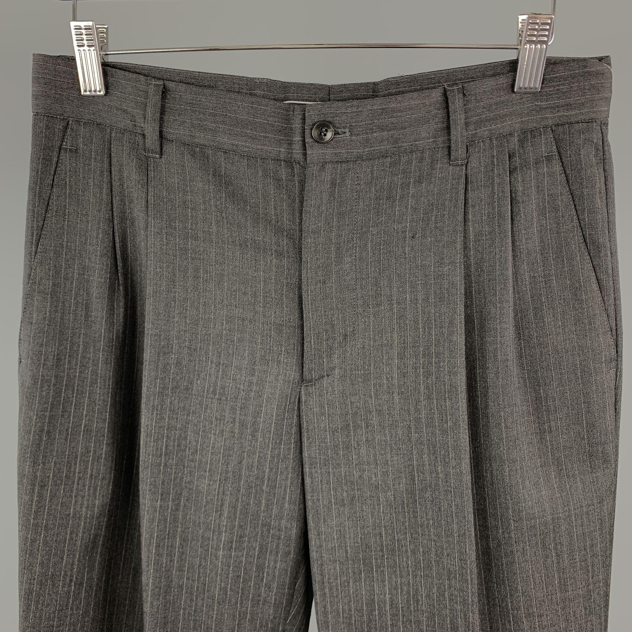 MIU MIU dress pants comes in a striped gray wool material, featuring a pleated front, zip fly, and seam and slit pockets. Made in Italy.

Excellent Pre-Owned Condition.
Marked: IT 46 

Measurements:

Waist: 32 in. 
Rise: 10 in. 
Inseam: 31 in.