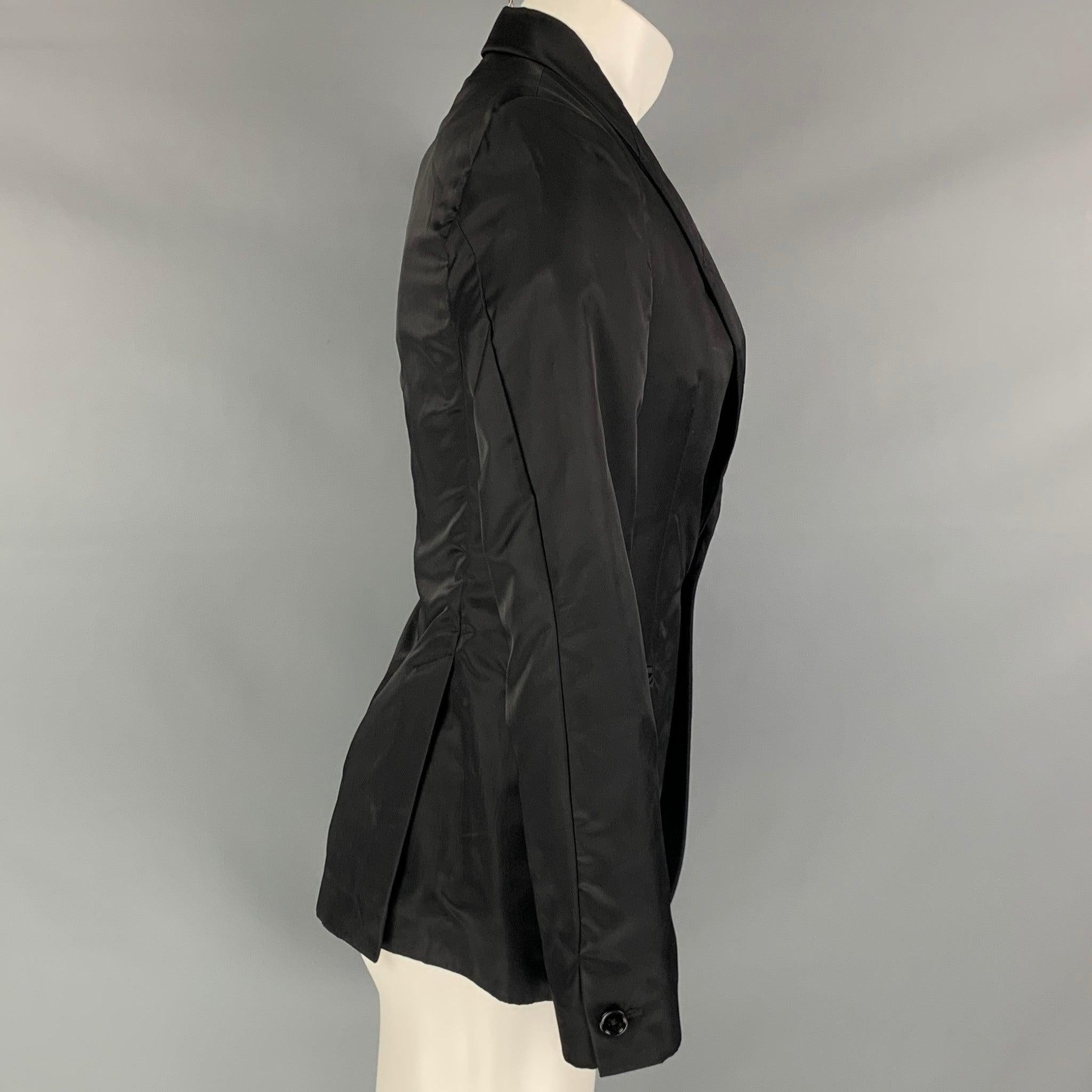 MIU MIU sport coat comes in a black woven material with a full liner featuring a shawl collar, slit pockets, double back vent, shoulder pads, and a single button closure. Made in Italy.Good Pre-Owned Condition. Tags removed and minor signs of wear.