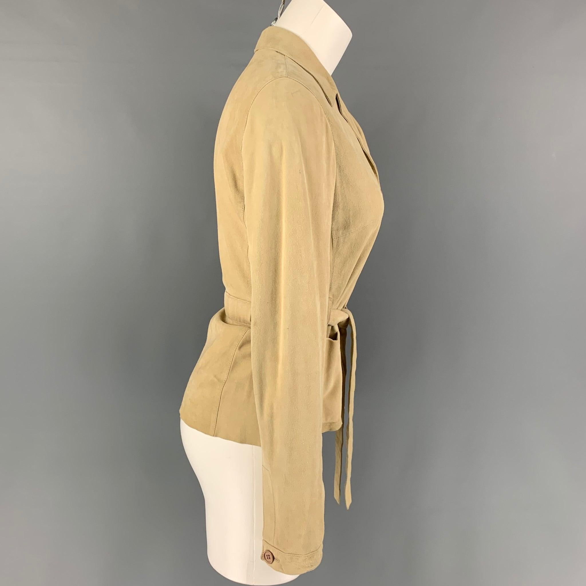 MIU MIU jacket comes in a beige suede featuring a notch lapel, patch pockets, belted, and a buttoned closure. Made in Italy.
Good
Pre-Owned Condition.
Light wear & marks throughout. As-Is.  

Marked:   40 

Measurements: 
 
Shoulder:
16 inches 