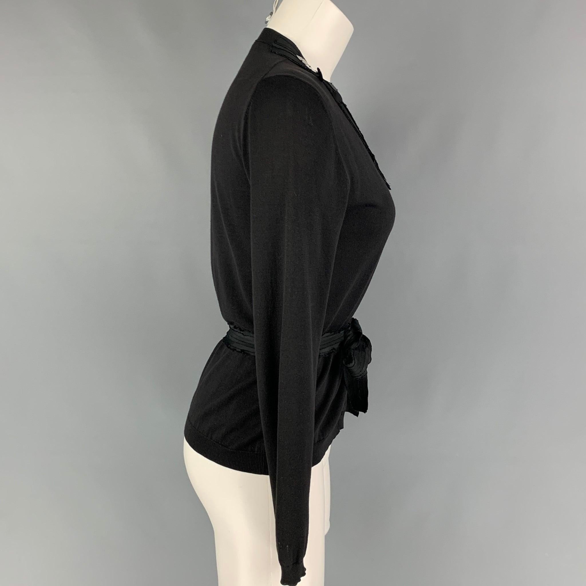 MIU MIU cardigan comes in a black cotton featuring payette sequins details, pleated trim, textured belt, and a buttoned closure. Made in Italy.
 Very Good
 Pre-Owned Condition. 
 

 Marked:  40 
 

 Measurements: 
  
 Shoulder: 15.5 inches Bust: 33