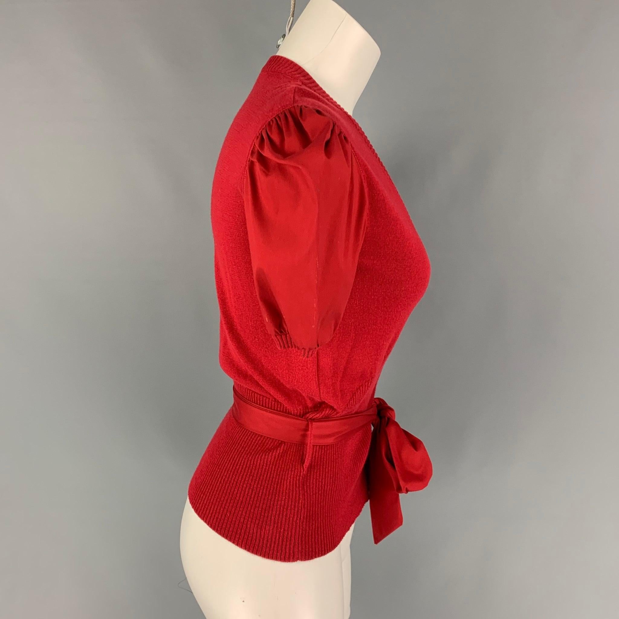 MIU MIU cardigan comes in a red cotton blend featuring short sleeves, self-tie belt, and a buttoned closure. Made in Italy.
Very Good
Pre-Owned Condition. 

Marked:   40 

Measurements: 
 
Shoulder:
15.5 inches  Bust: 32 inches Sleeve: 10.5 inches 
