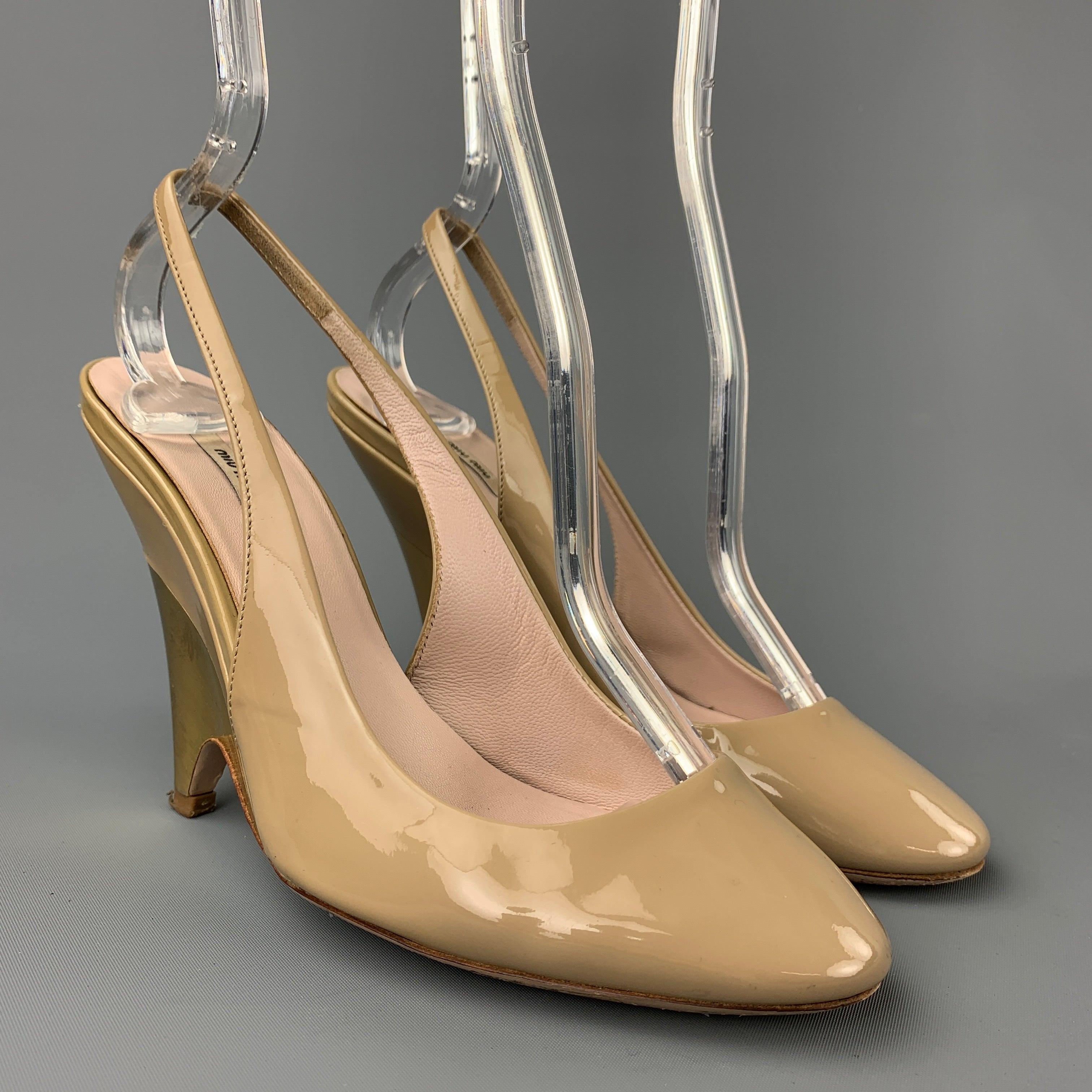 MIU MIU pumps comes in beige patent leather with a gold tone heel featuring a slingback. Made in Italy.
Good
Pre-Owned Condition. 

Marked:   EU 35.5 

Measurements: 
  Heel:
4 inches  
  
  
 
Reference: 108121
Category: Pumps
More Details
   