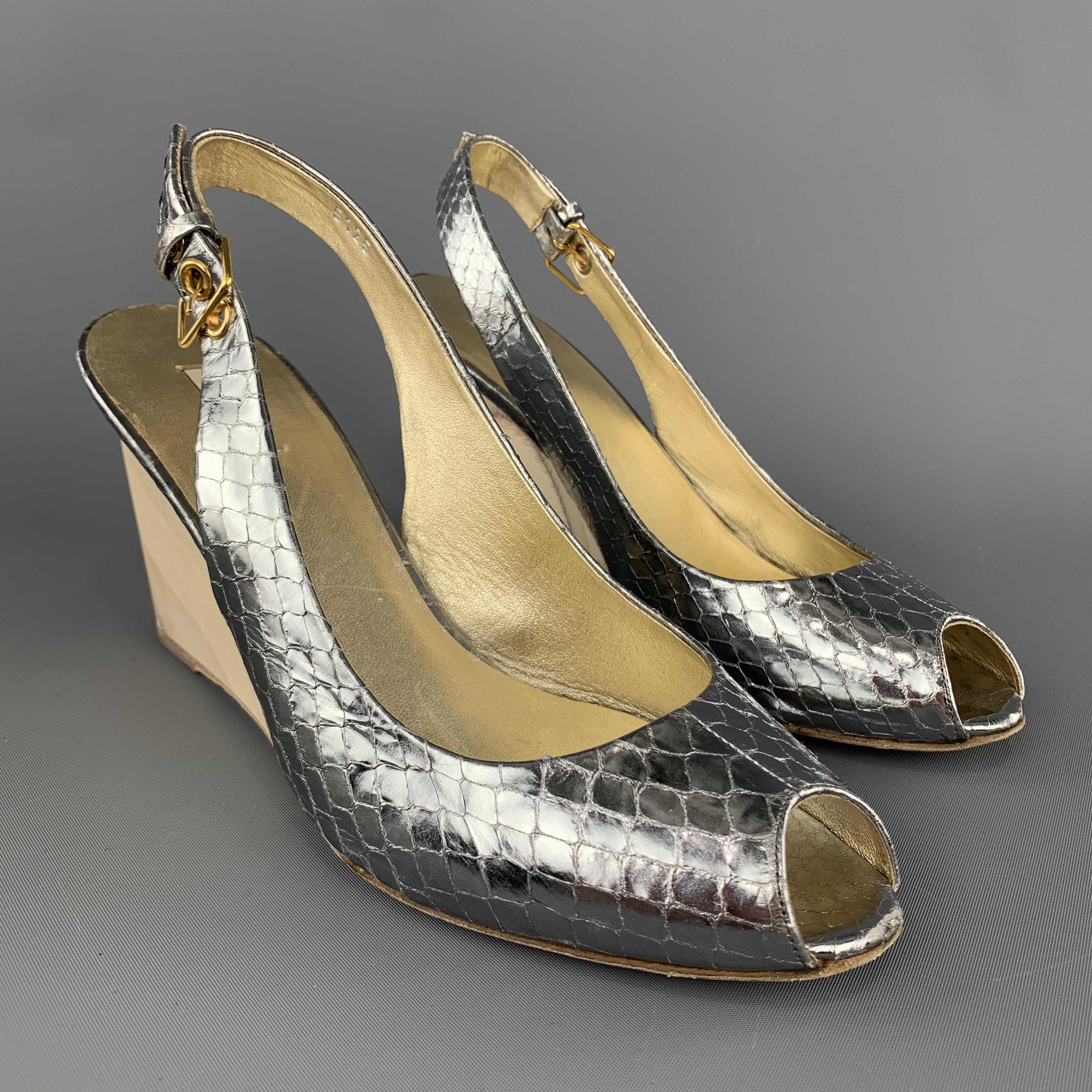 MIU MIU sandals come in metallic silver snake skin leather with a sling back, peep toe, and wooden wedge heel. Scuff on toe. Made in Italy.

Very Good Pre-Owned Condition.
Marked: IT 37

Measurements:

Heel: 3.5 in. 