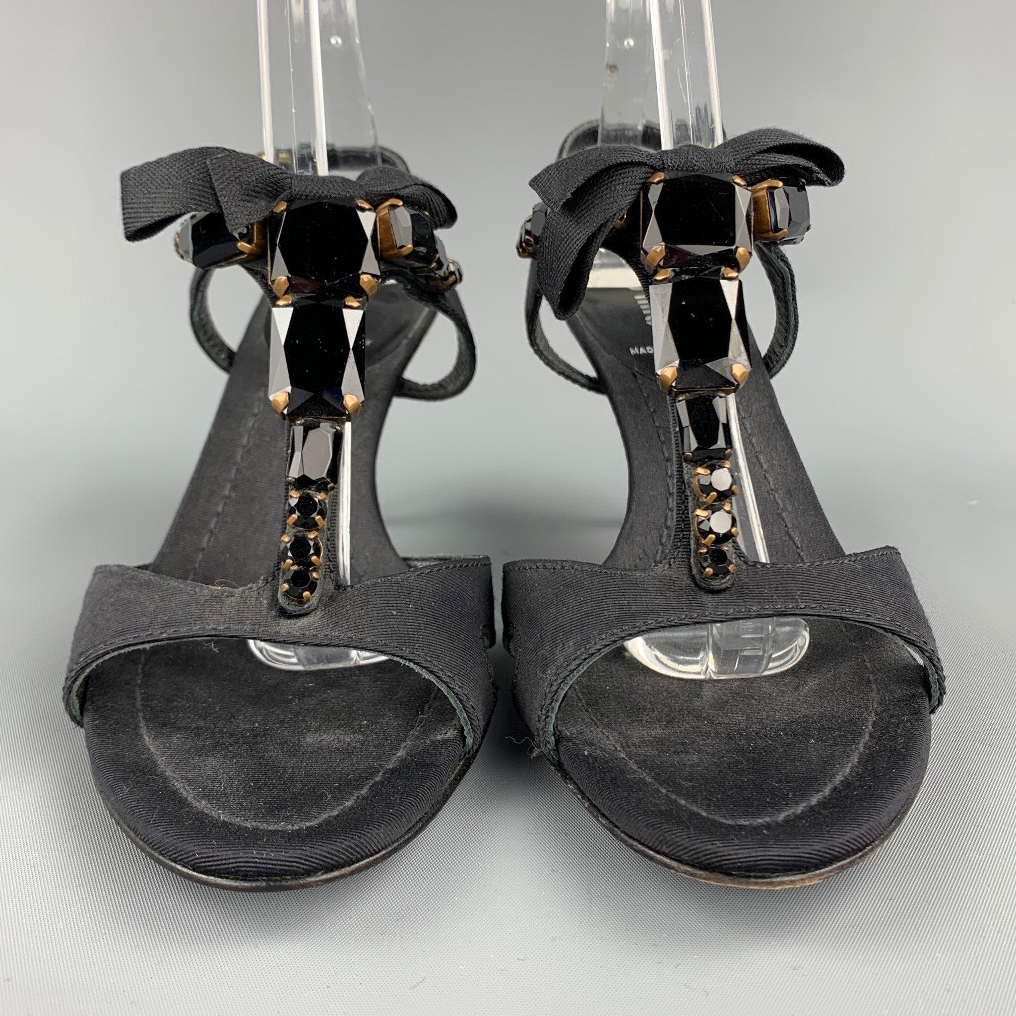 MIU MIU sandals comes in a black fabric with rhinestone details featuring a strap closure. Made in Italy. Minor wear.Good
Pre-Owned Condition. 

Marked:   EU 37.5 

Measurements: 
  Heel: 3 inches 
  
  
 
Reference: 105959
Category: Sandals
More