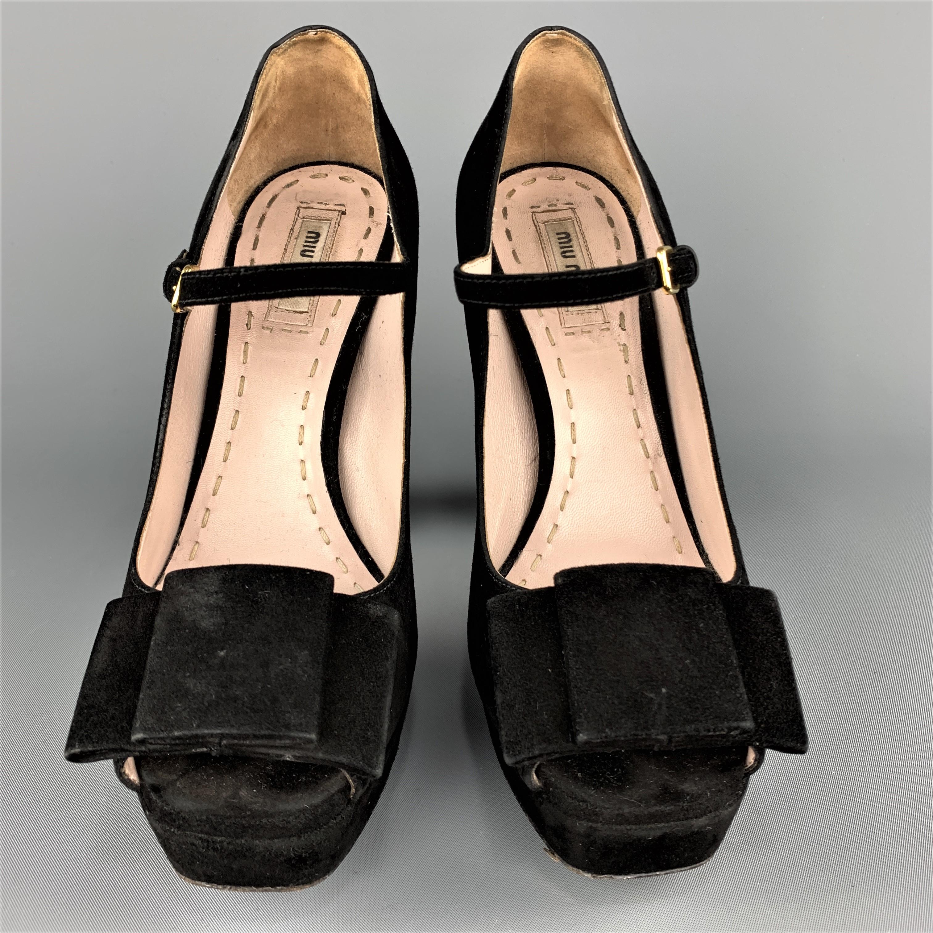 MIU MIU pumps come in black suede with a chunky covered heel, peep toe, bow detail, and Mary Jane strap. Wear throughout. Made in Italy.
 
Good Pre-Owned Condition.
Marked: IT 38
 
Measurements:
 
Heel: 5 in.
Platform: 1 in.