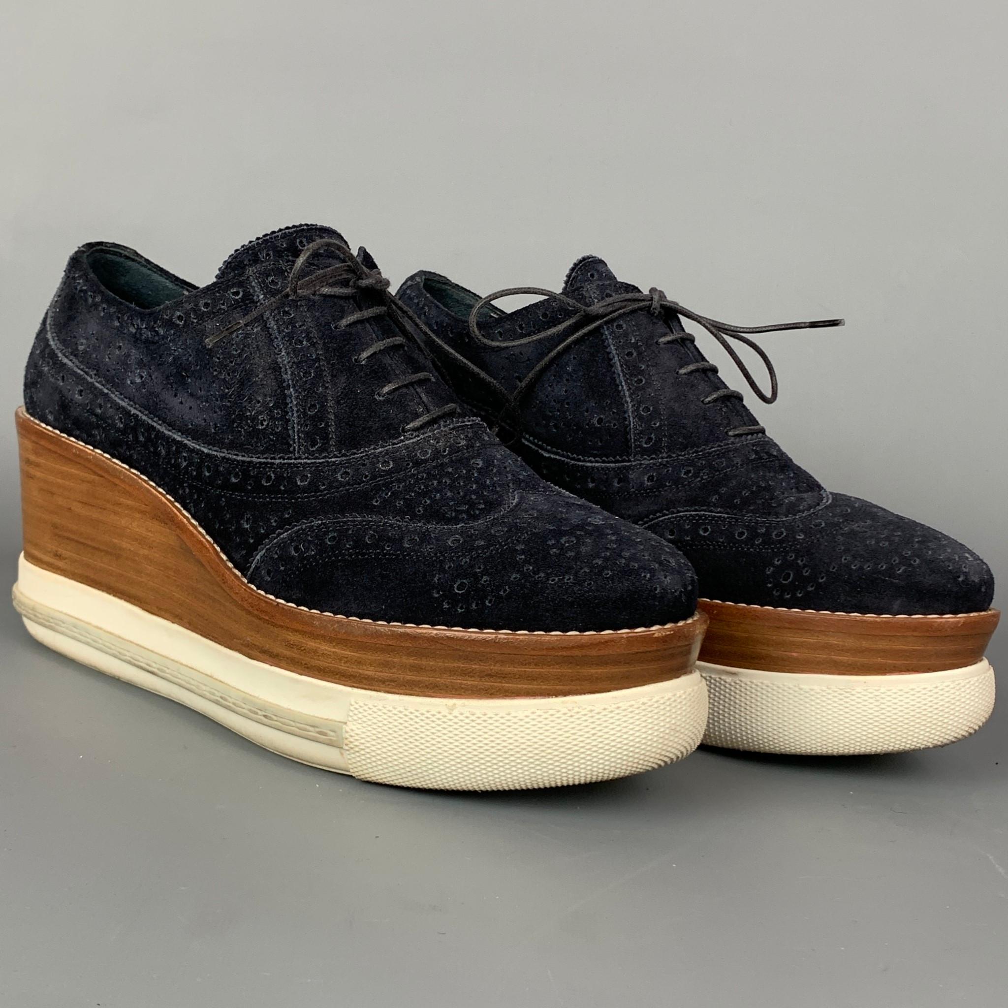MIU MIU shoes comes in a navy perforated suede featuring a oxford style, wooden platform, rubber sole, and a lace up closure.

Good Pre-Owned Condition.
Marked: 38.5

Measurements:

Heel: 3.5 in.
Platform: 1.5 in.

SKU: 109916
Category: Laces

More