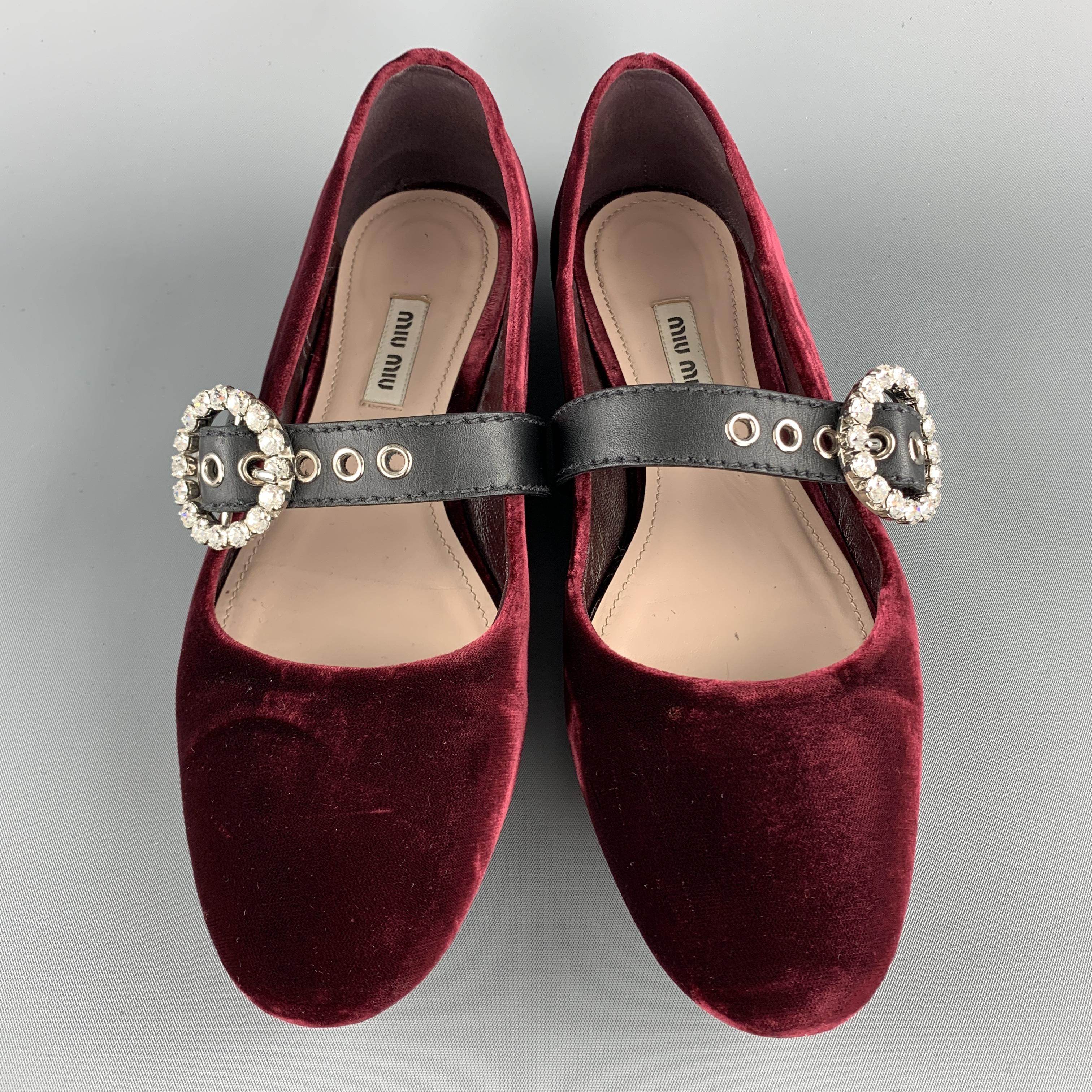 MIU MIU flats come in burgundy velvet with a leather Mary Jane strap accented with a round rhinestone studded buckle. Made in Italy.

Very Good  Pre-Owned Condition.
Marked: IT 39

Outsole: 10.5 x 3.5 in.