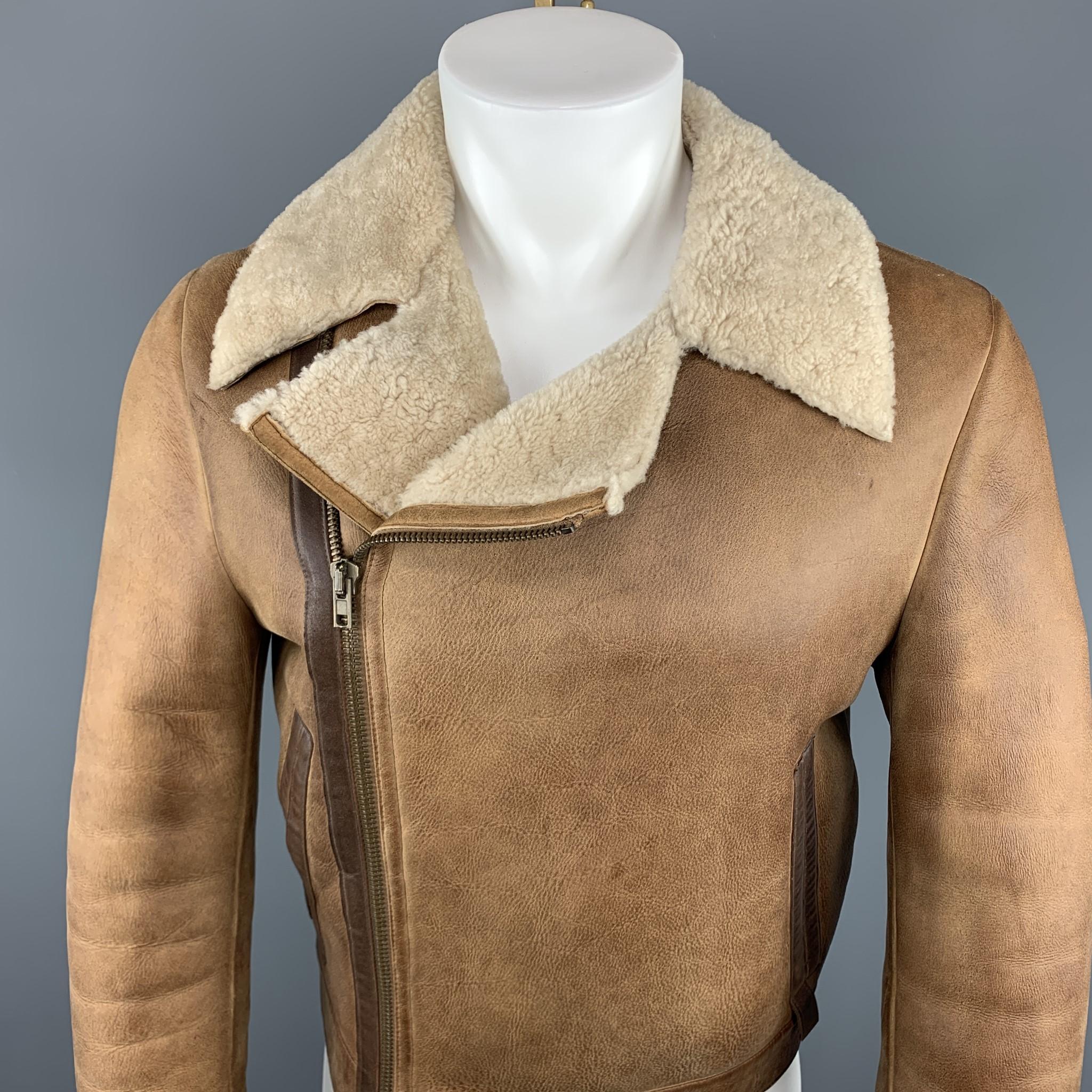 Vintage MIU MIU Jacket comes in a tan distressed shearling featuring a biker style, brown trim, and a full zip closure. Made in Italy.

Very Good Pre-Owned Condition.
Marked: 46

Measurements:

Shoulder: 18 in.
Chest: 36 in.
Sleeve: 26 in.
Length: